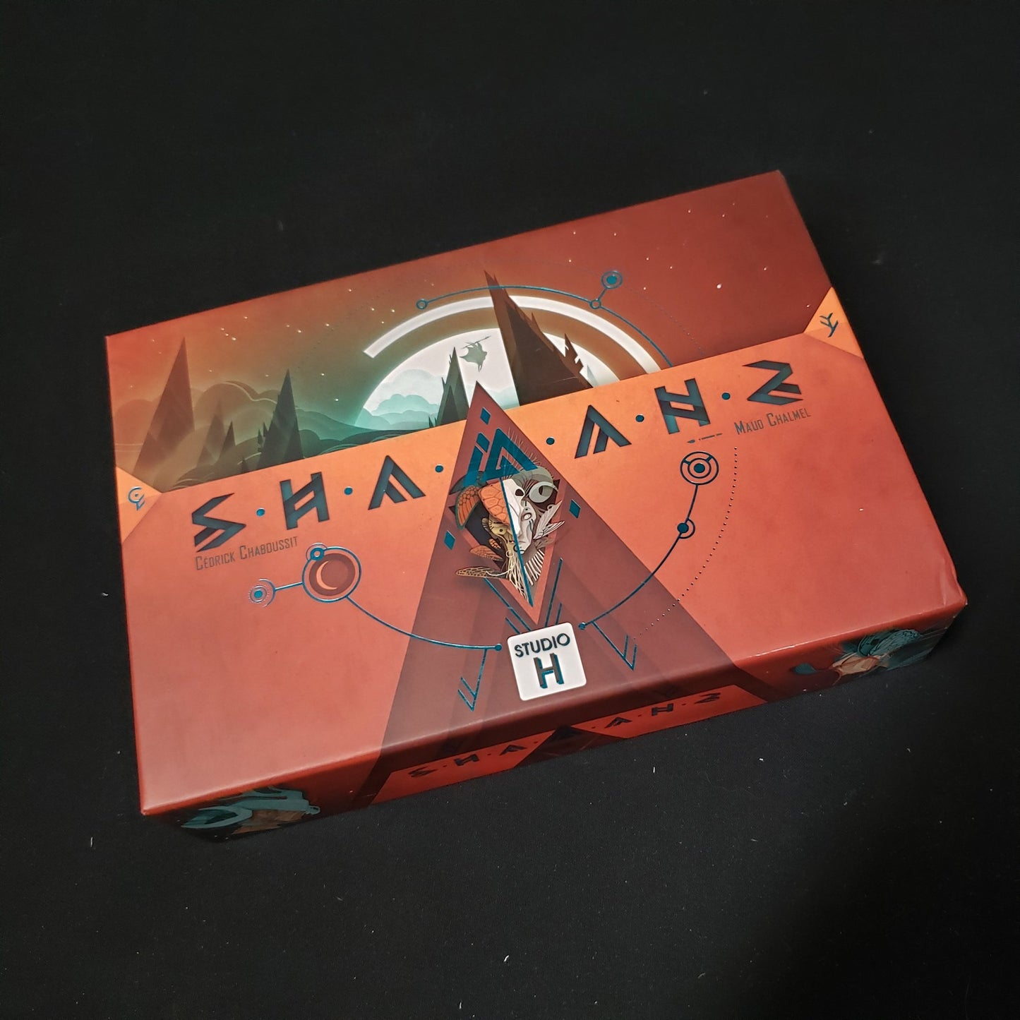Image shows the front cover of the box of the Shamans card game