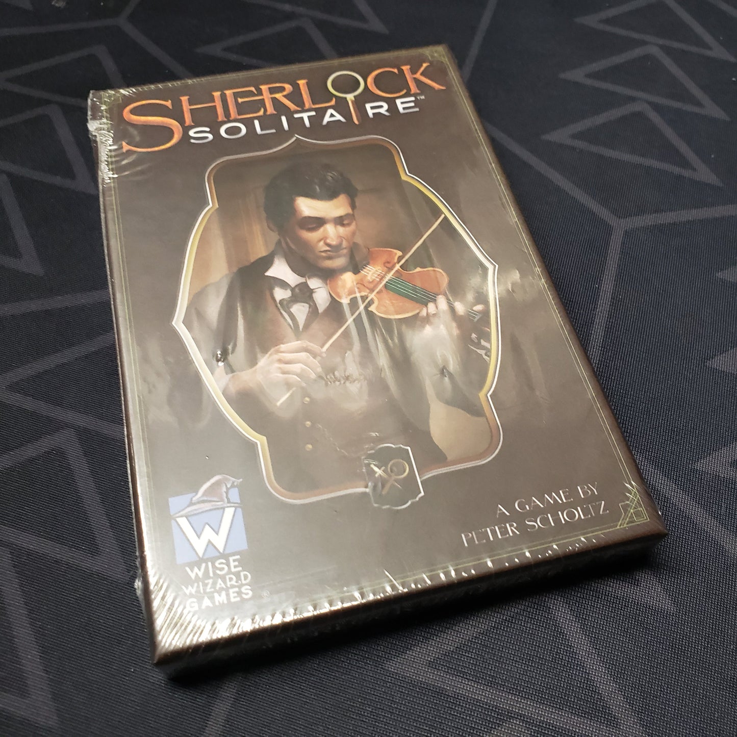Image shows the front cover of the box of the Sherlock Solitaire card game