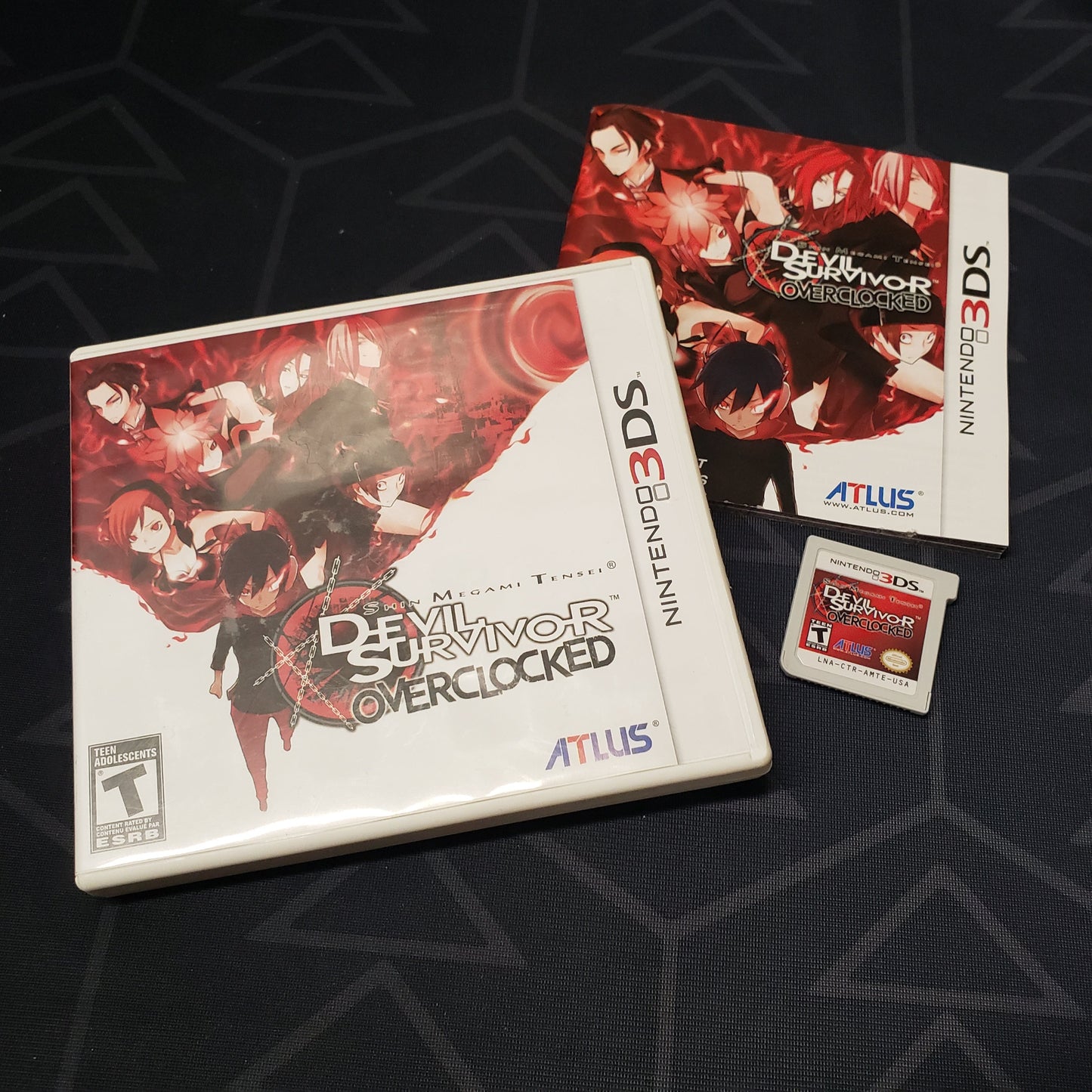 Image shows the case, manual and cartridge for the video game Shin Megami Tensei: Devil Survivor Overclocked for Nintendo 3DS
