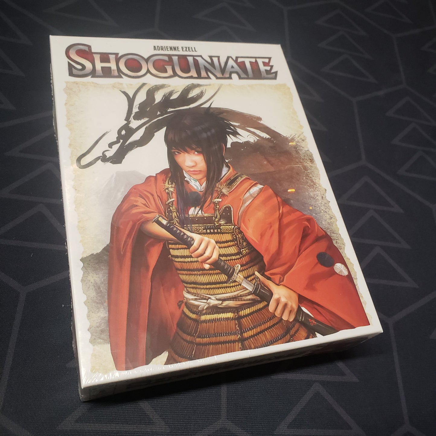 Image shows the front cover of the box of the Shogunate card game