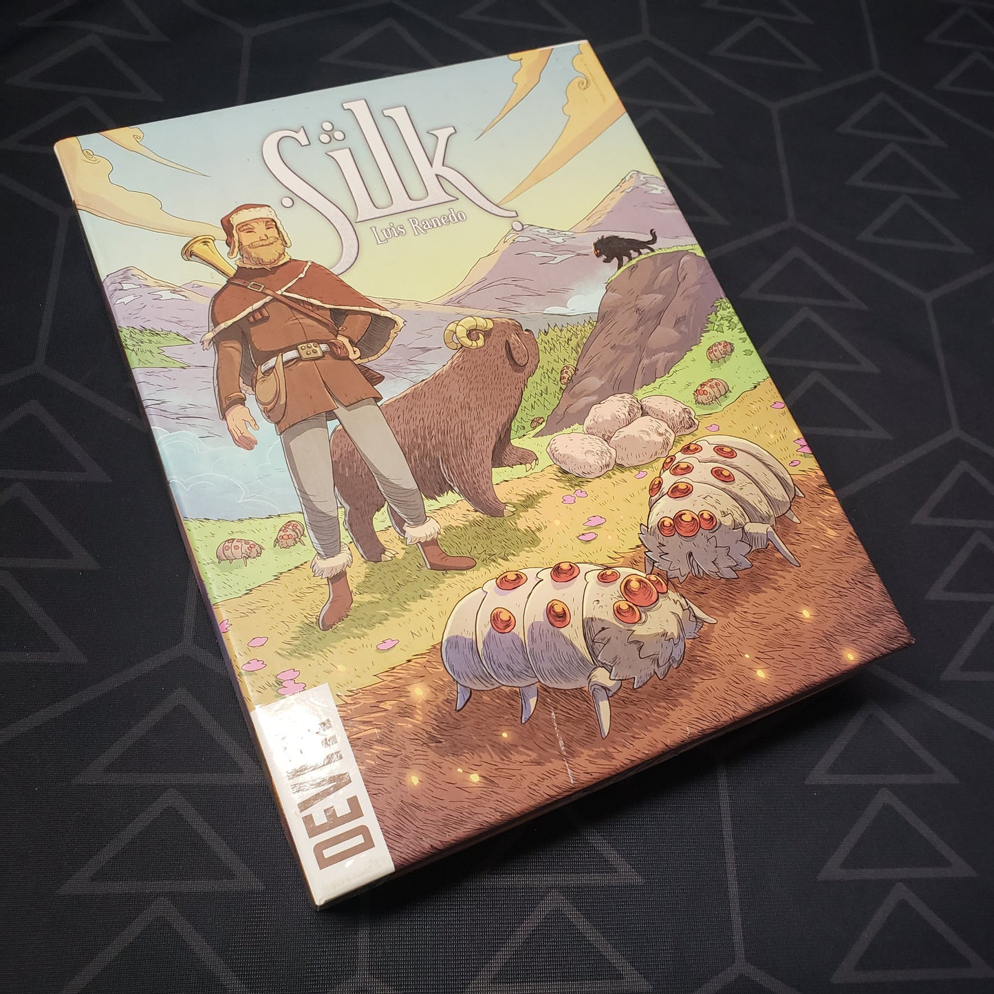 Image shows the front cover of the box of the Silk board game