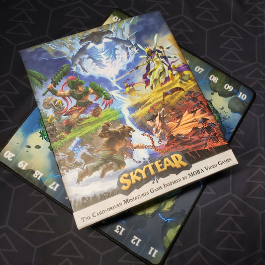 Image shows the front cover of the box for the Skytear board game, sitting on top of the neoprene playmat for the game