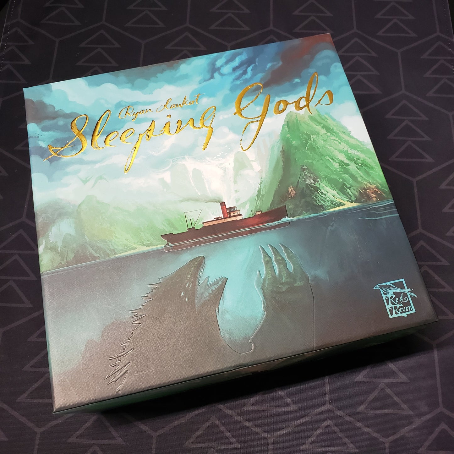Image shows the front cover of the Kickstarter Edition box for the board game Sleeping Gods