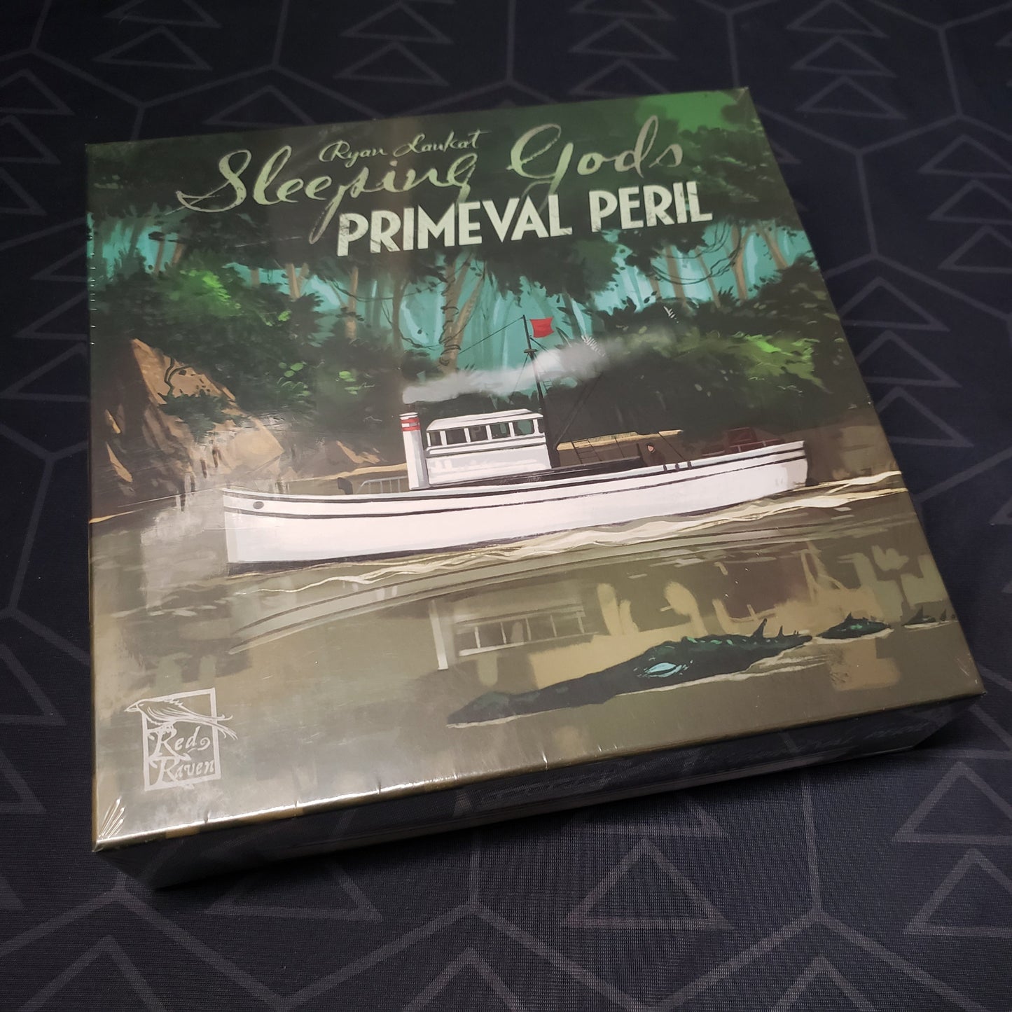 Image shows the front cover of the box for the Sleeping Gods: Primeval Peril board game