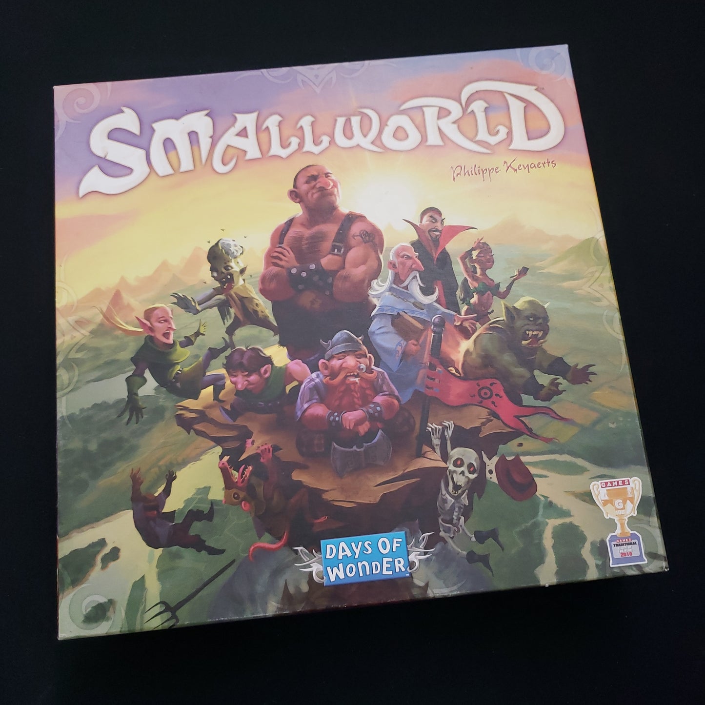 Image shows the front cover of the box of the Small World board game