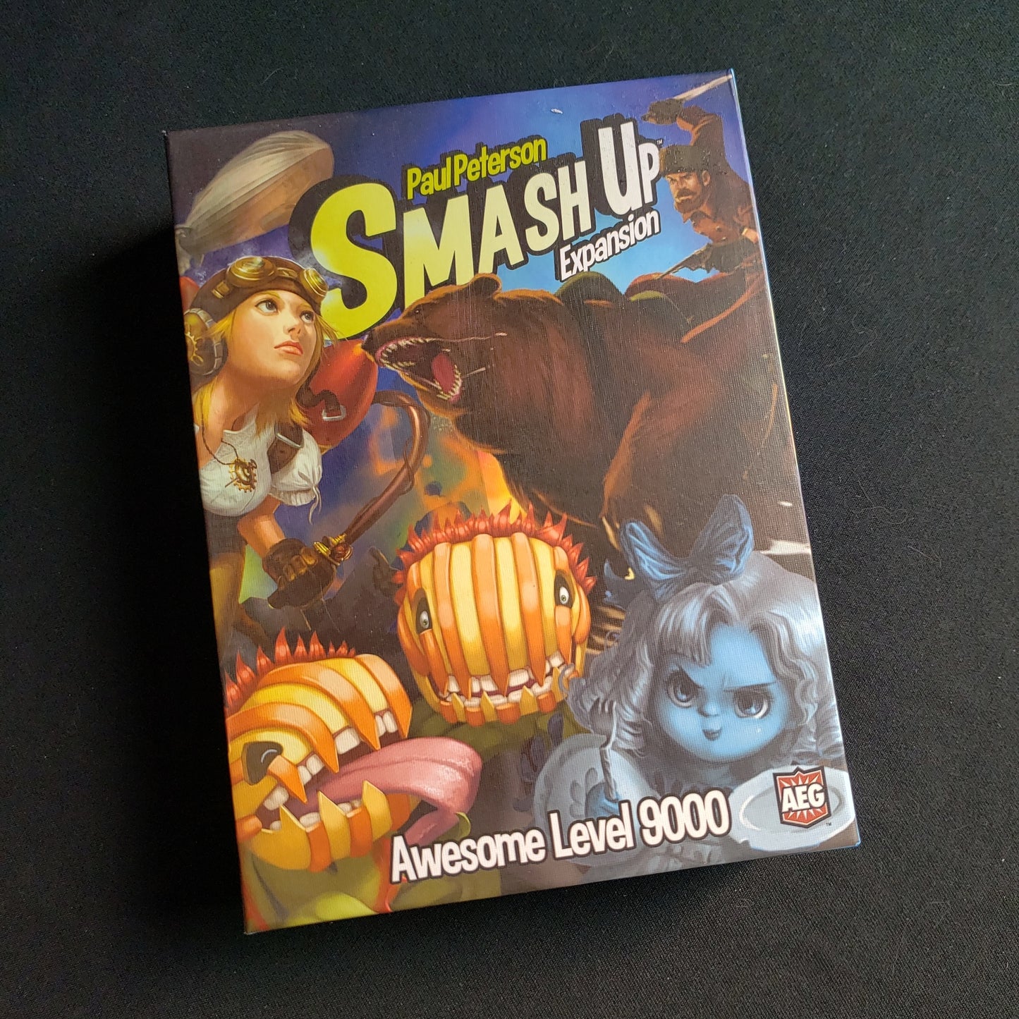 Image shows the front of the box for the Awesome Level 9000 Expansion for the Smash Up card game