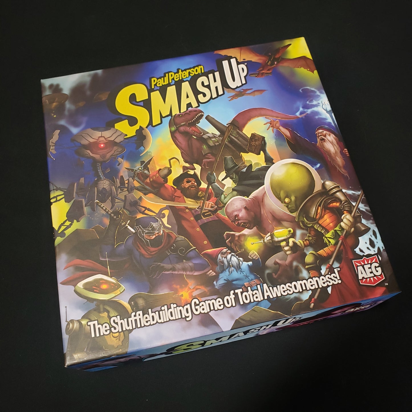 Image shows the front cover of the box of the Smash Up card game