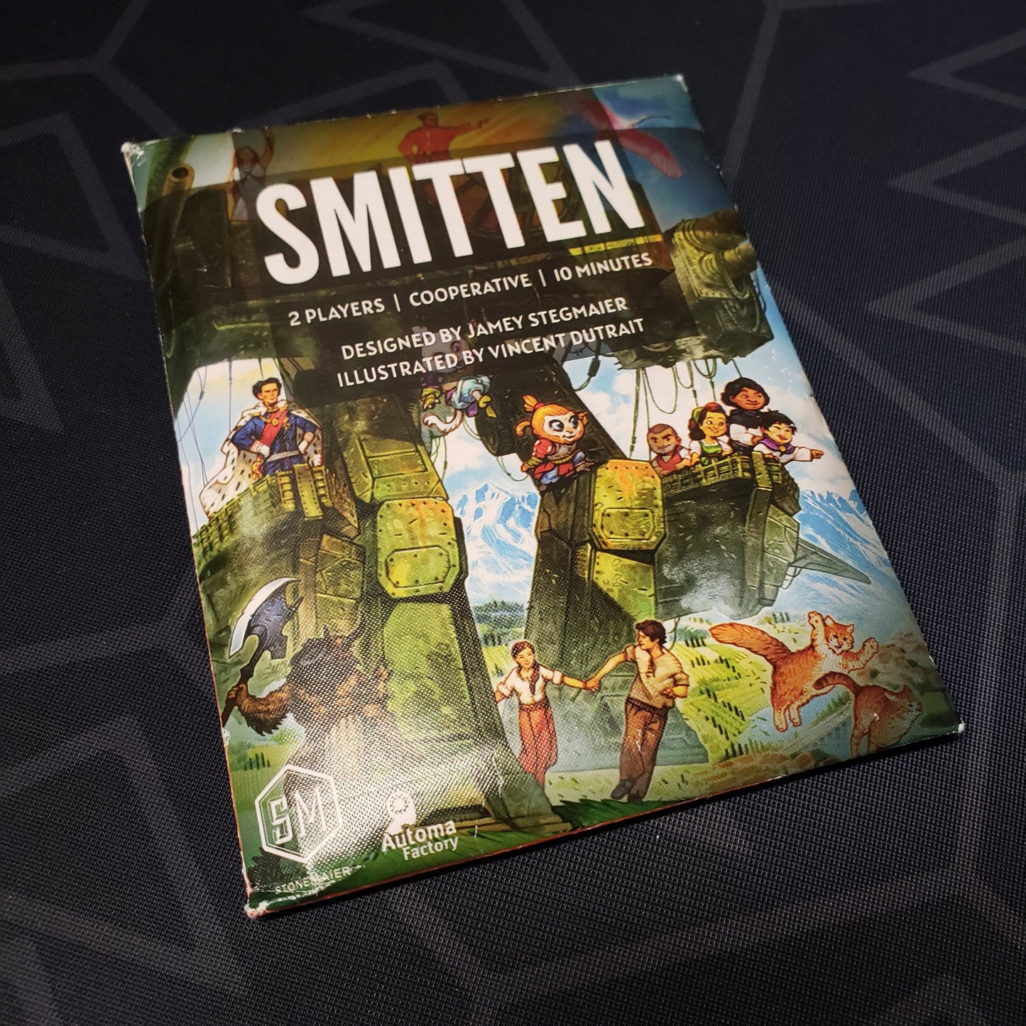 Image shows the front of the packaging for the Smitten card game