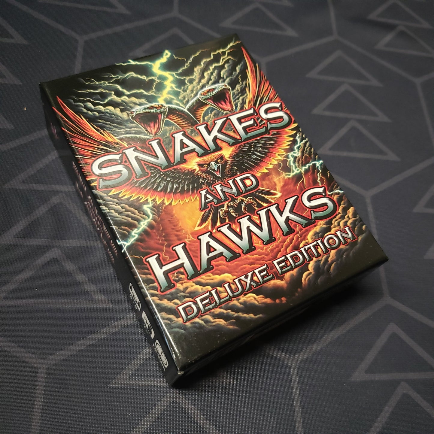 Image shows the front cover of the box for the Snakes & Hawks (Deluxe Edition) card game