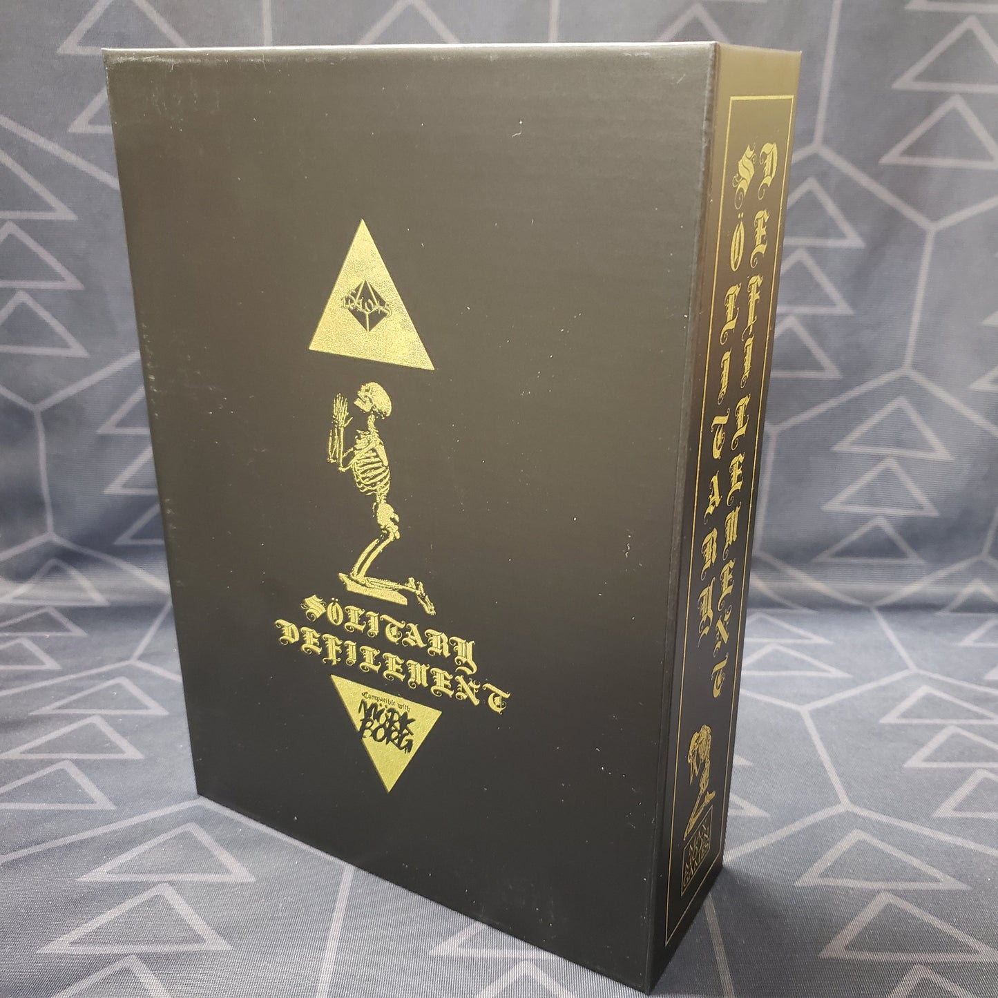 Image shows the front of the limited edition Futility of Prayer box for the roleplaying game Solitary Defilement