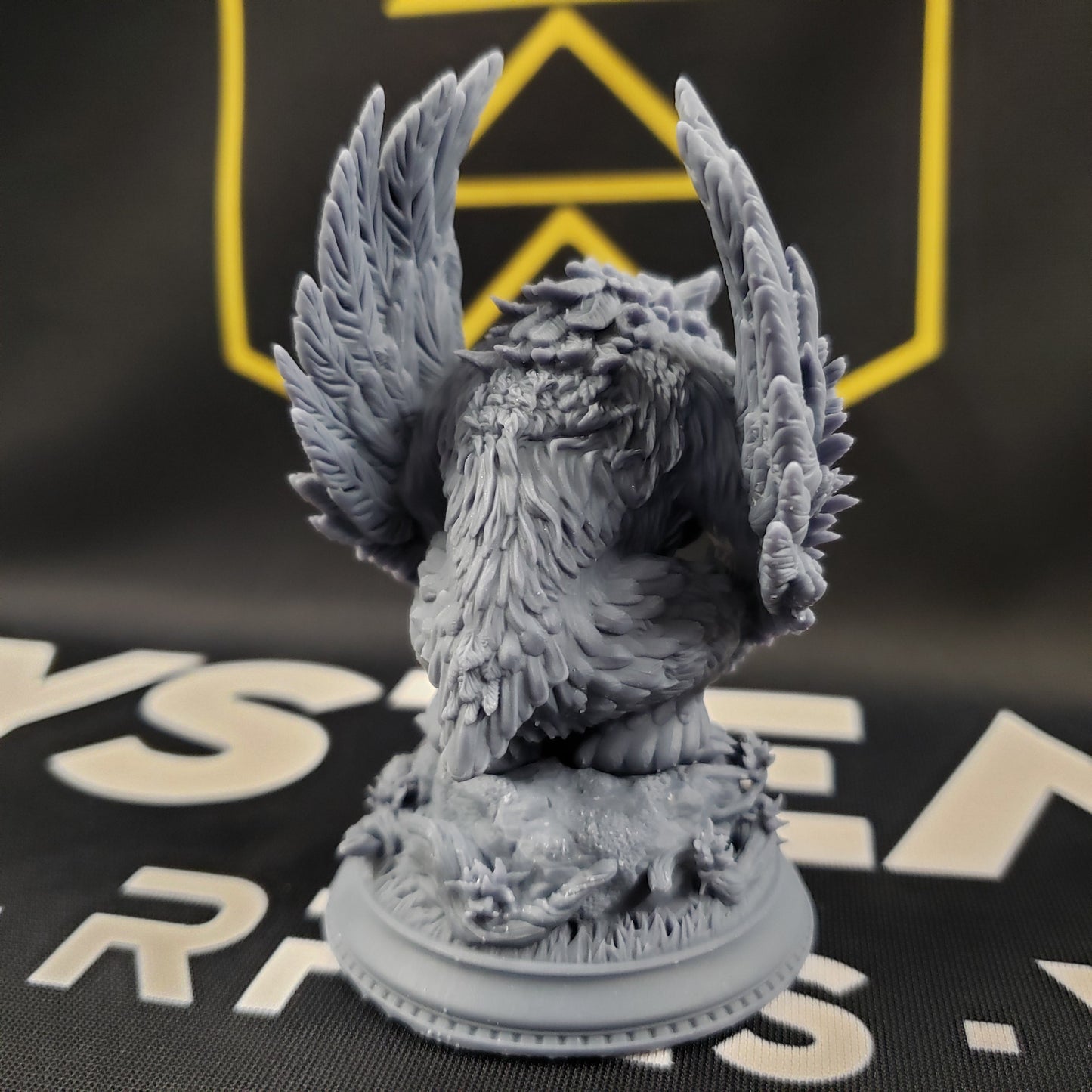 Image shows the back of a 3D printed owlbear gaming miniature