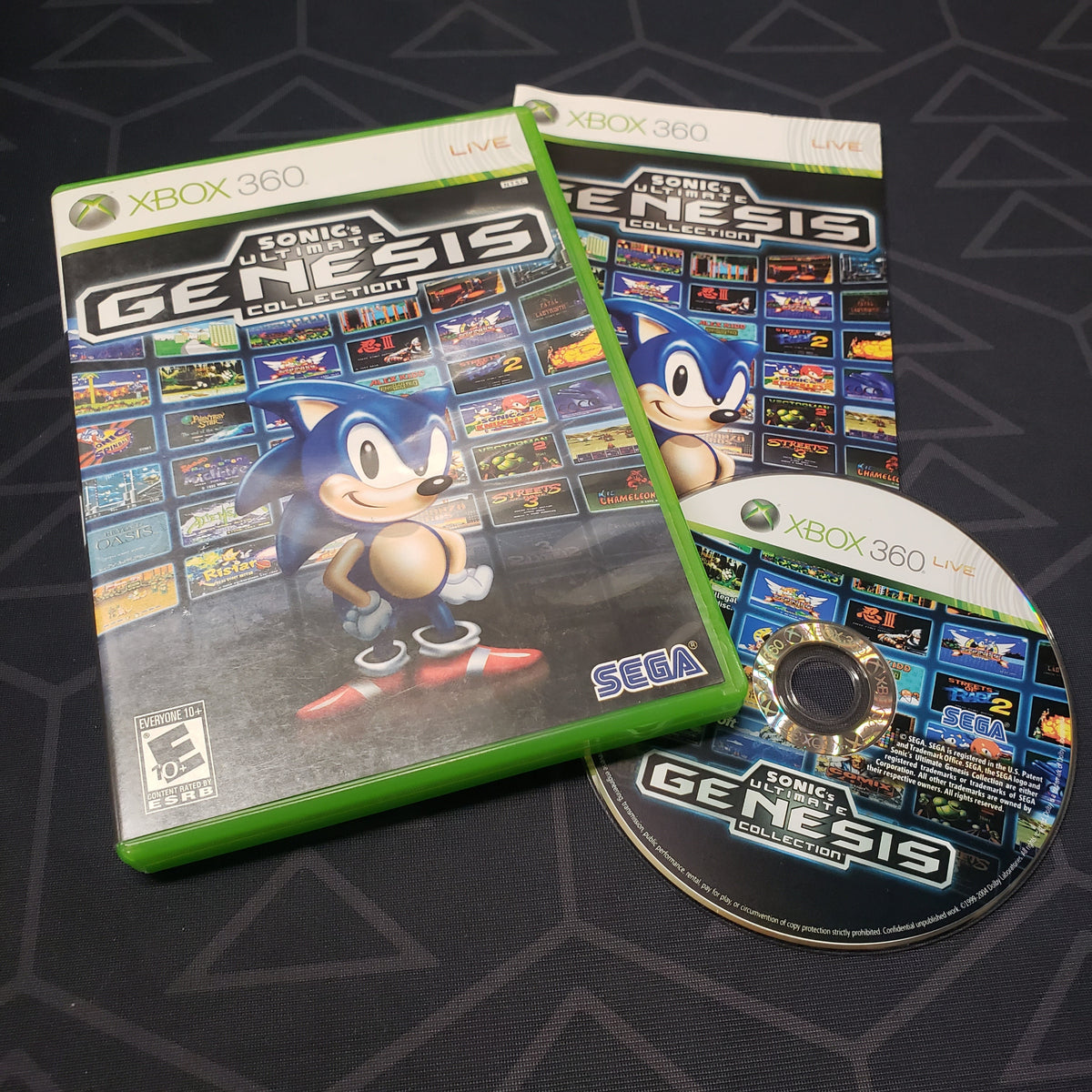 Image shows the case, manual and disc for the video game Sonic's Ultimate Genesis Collection for Xbox 360