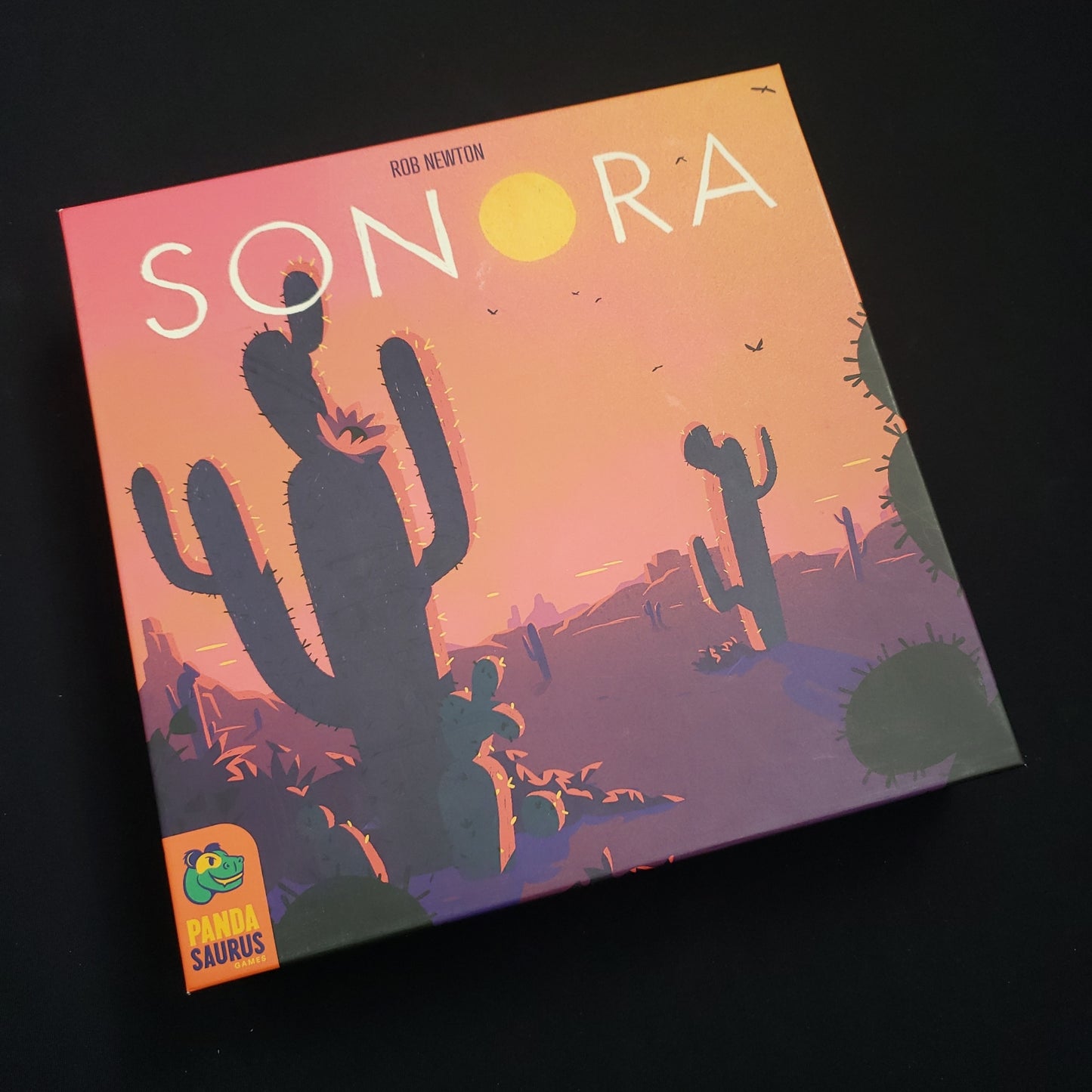 Image shows the front cover of the box of the Sonora board game
