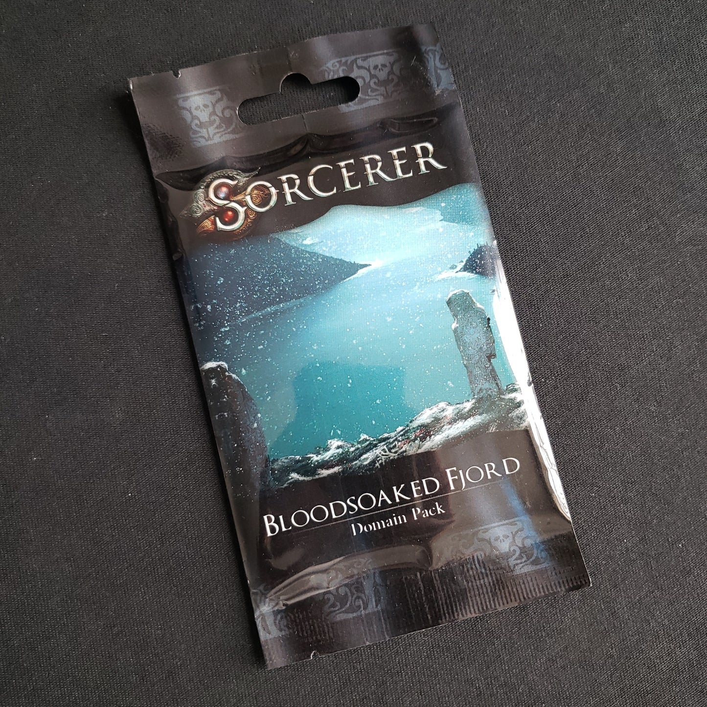 Image shows the front of the package for the Bloodsoaked Fjord Domain Pack for the card game Sorcerer