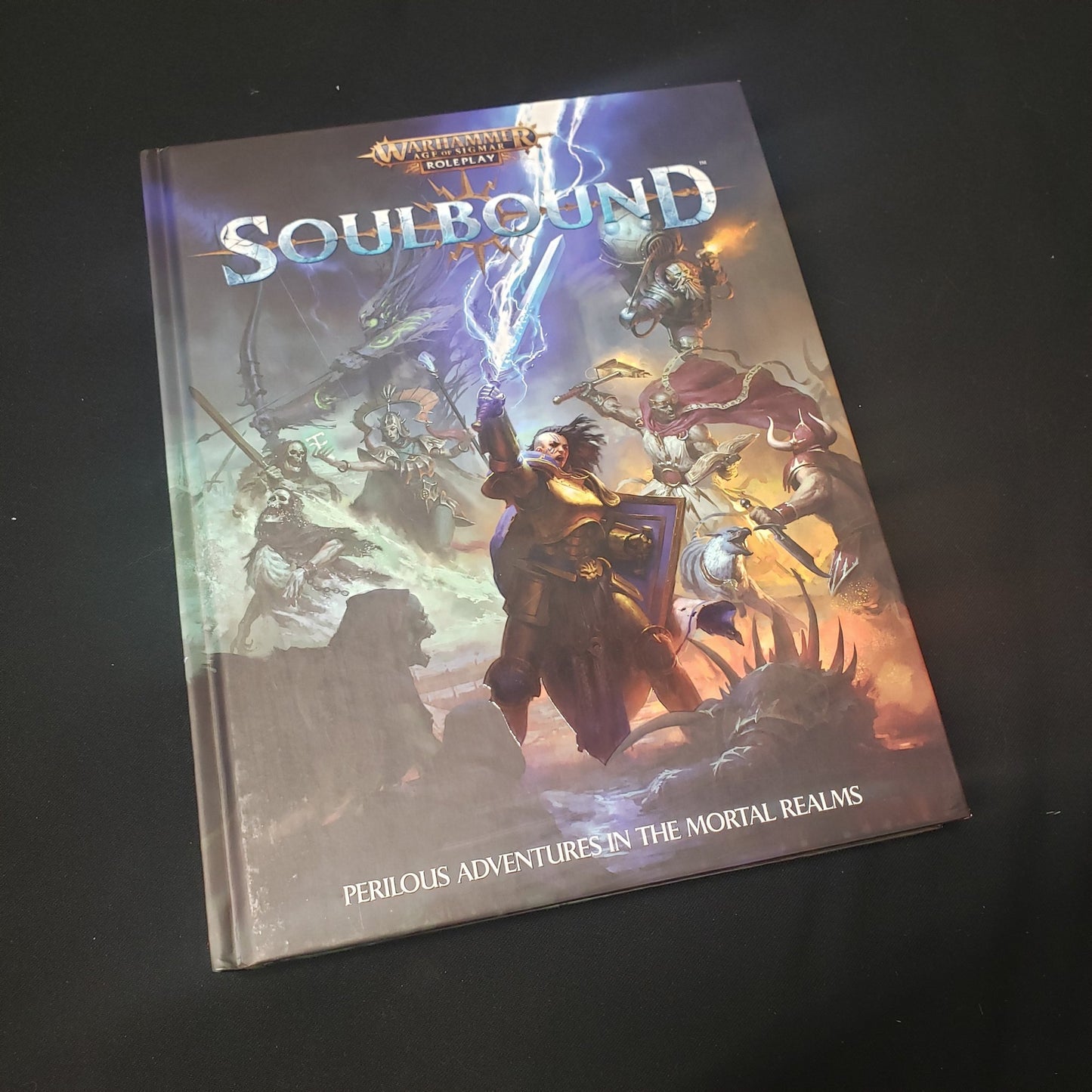 Image shows the front cover of the core rulebook for the roleplaying game Soulbound