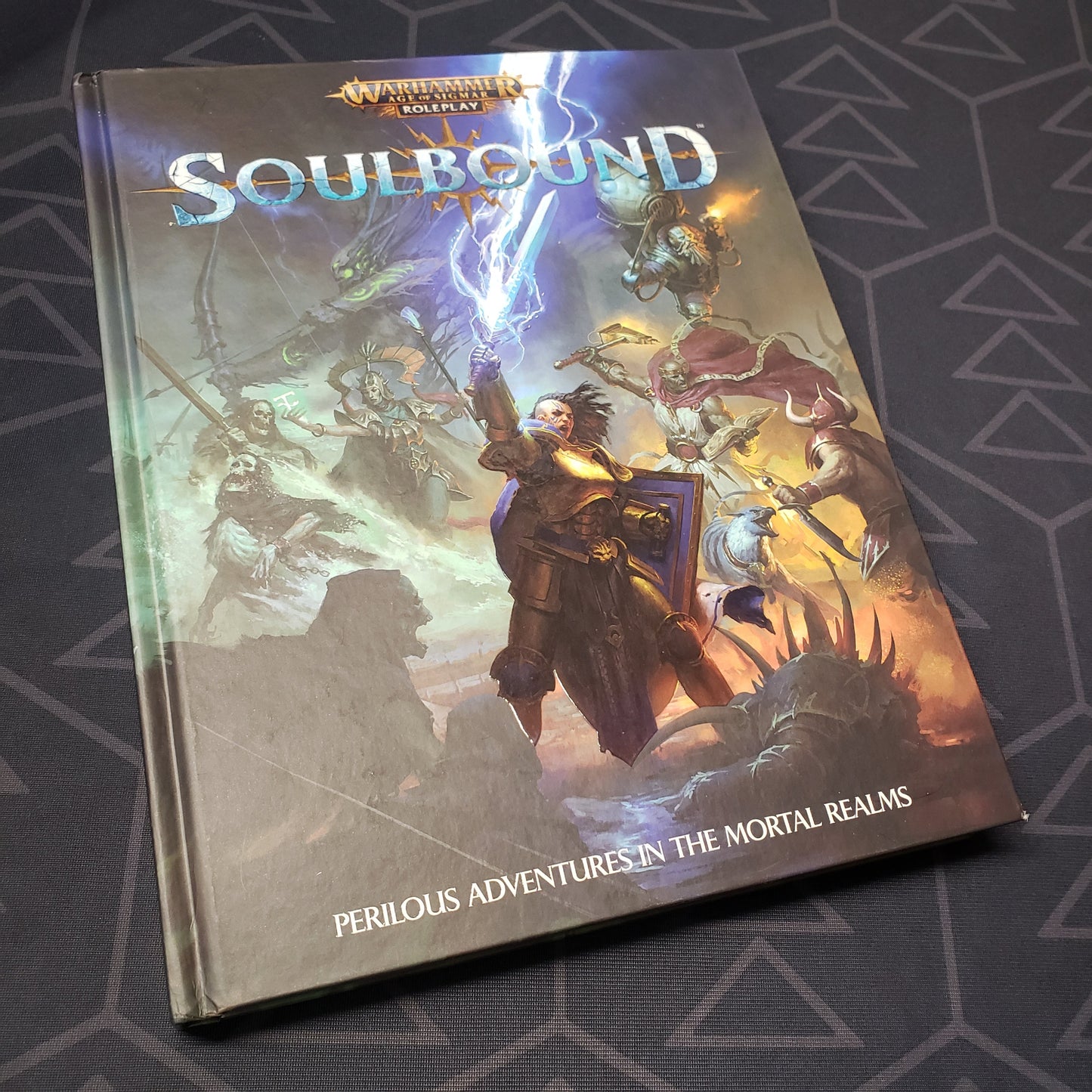 Image shows the front cover of the core rulebook for the roleplaying game Soulbound