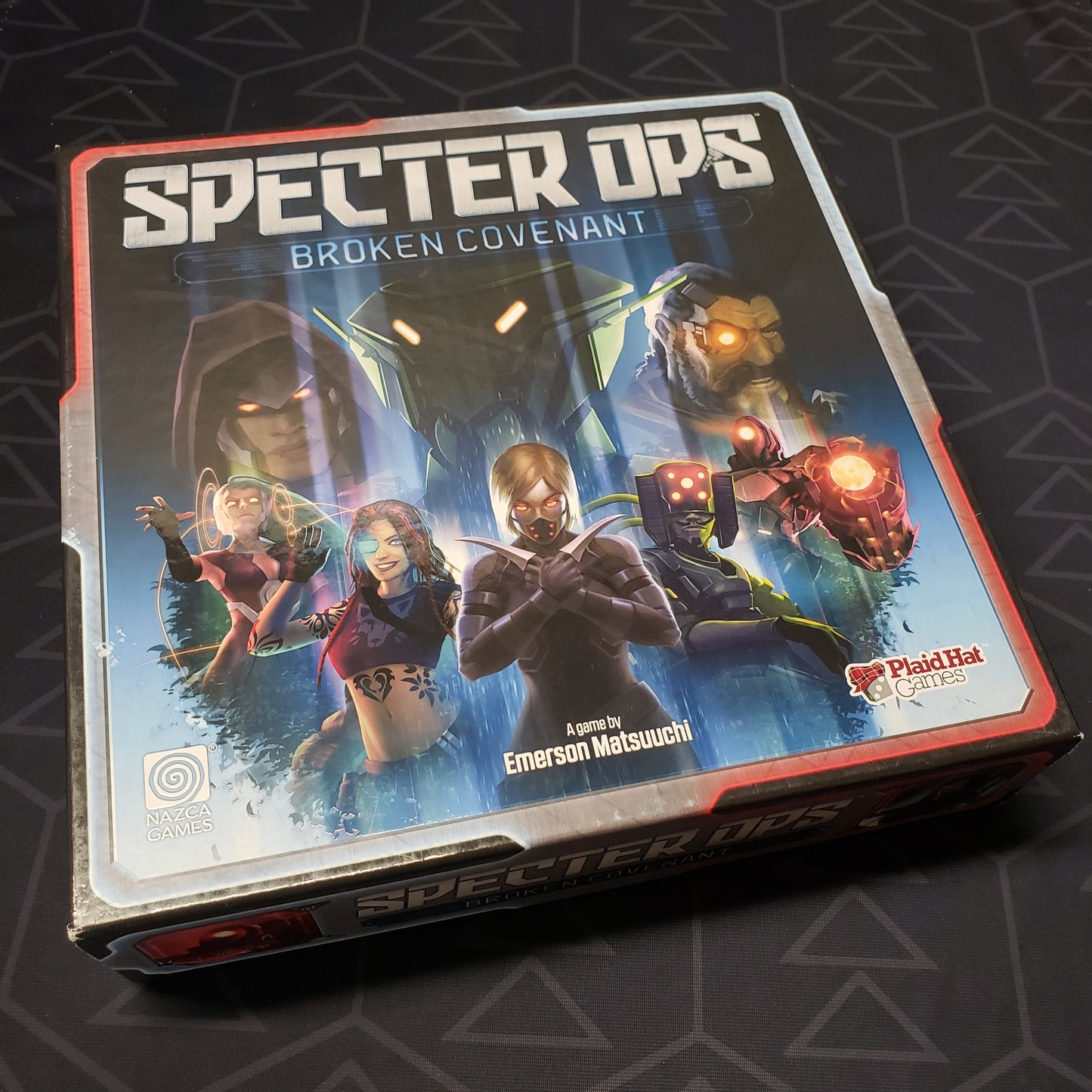 Image shows the front cover of the box for the Specter Ops: Broken Covenant board game