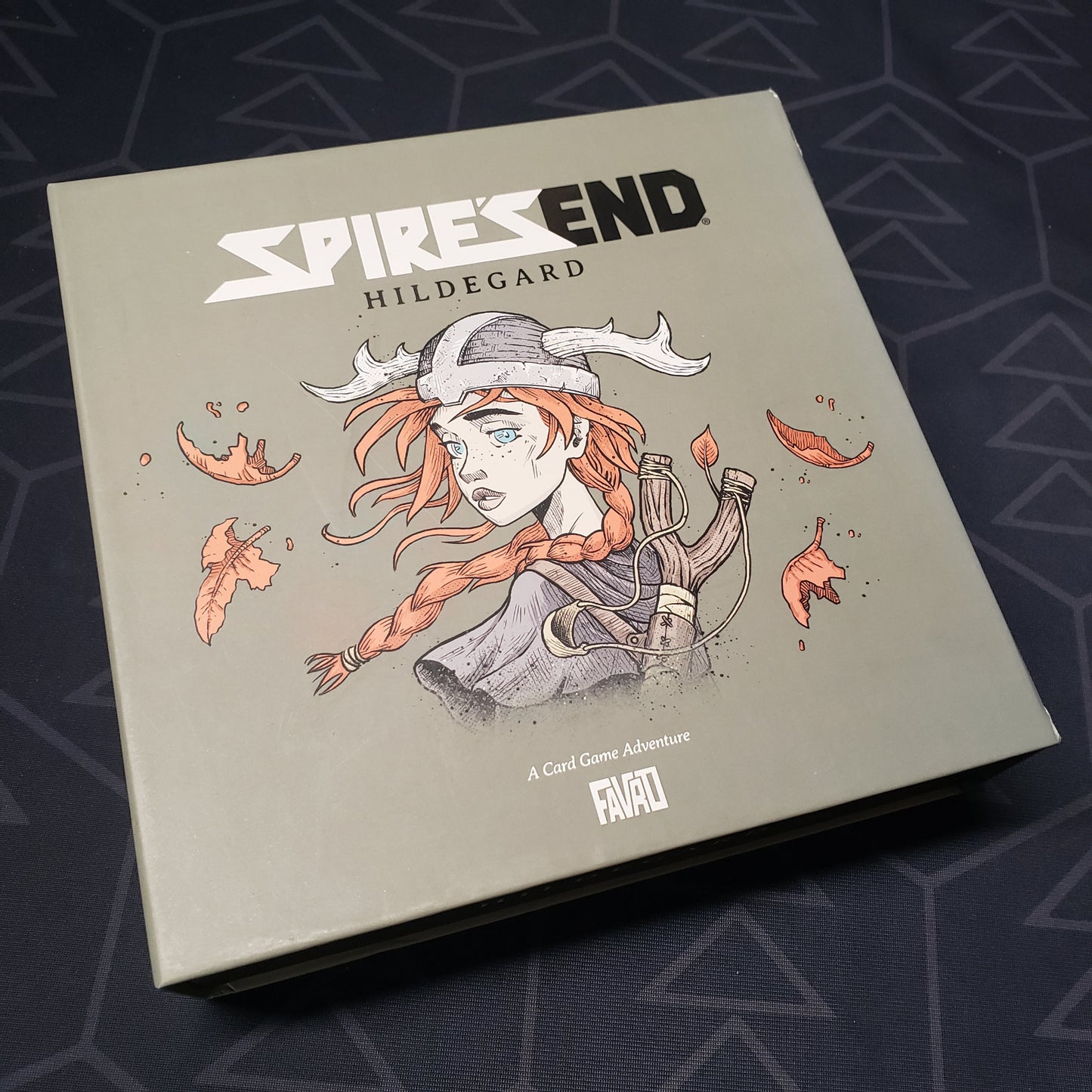 Image shows the front cover of the box of the Spire's End: Hildegard card game