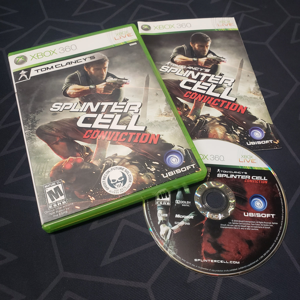 Image shows the case, manual and disc for the video game Splinter Cell: Conviction for Xbox 360