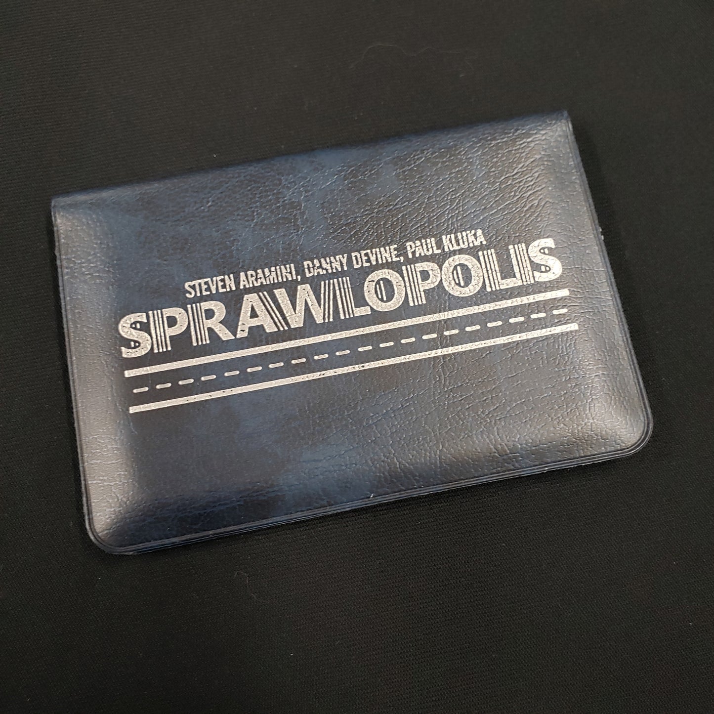 Image shows the front cover of the box of the Sprawlopolis card game