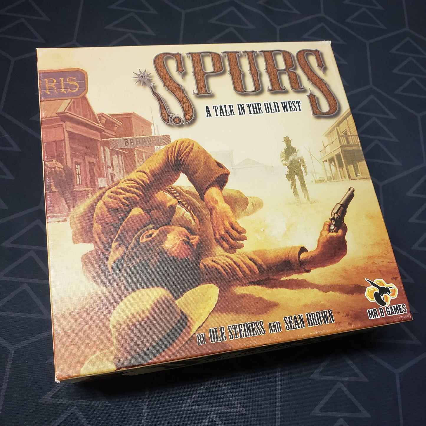 Image shows the front cover of the box of the Spurs board game
