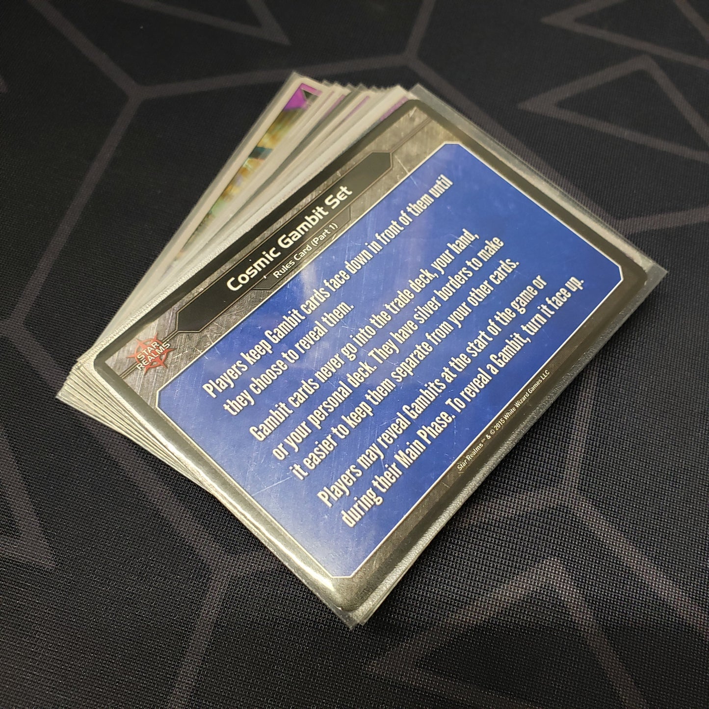 Image shows the cards for the Cosmic Gambit expansion for the card game Star Realms fanned out in a stack
