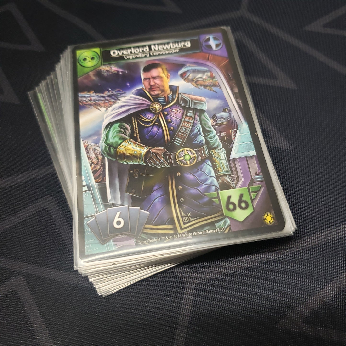 Image shows the cards for the Command Deck: The Pact expansion for the card game Star Realms fanned out in a stack