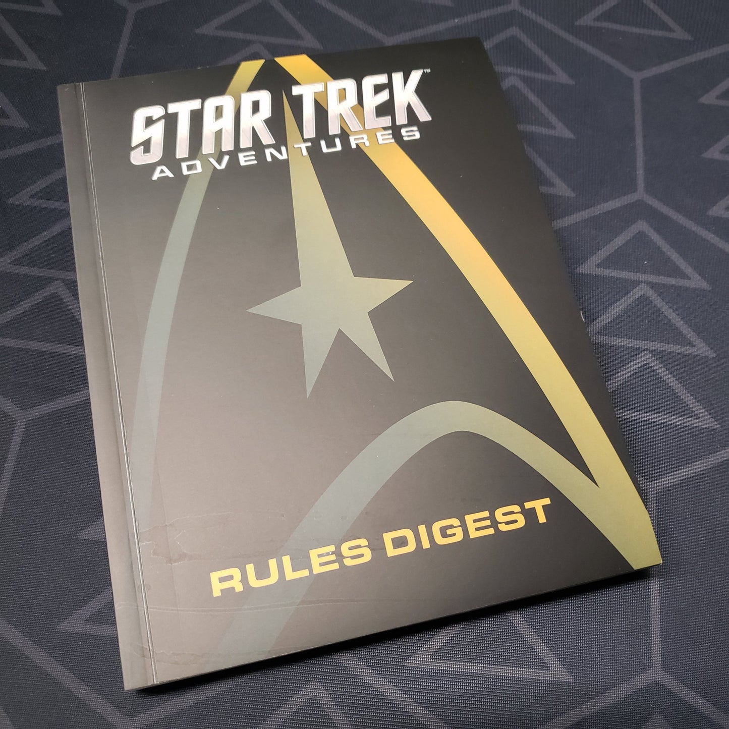 Image shows the front cover of the Rules Digest for the roleplaying game Star Trek Adventures
