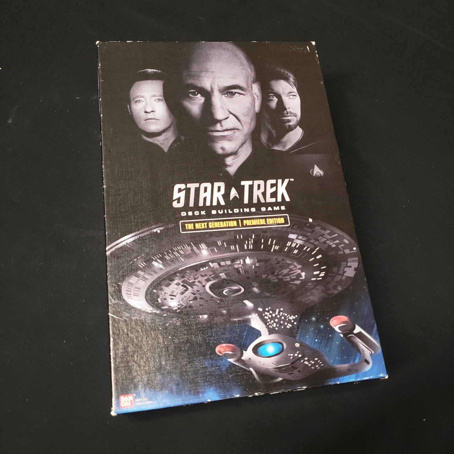 Image shows the front cover of the box of the card game Star Trek Deck Building Game: The Next Generation