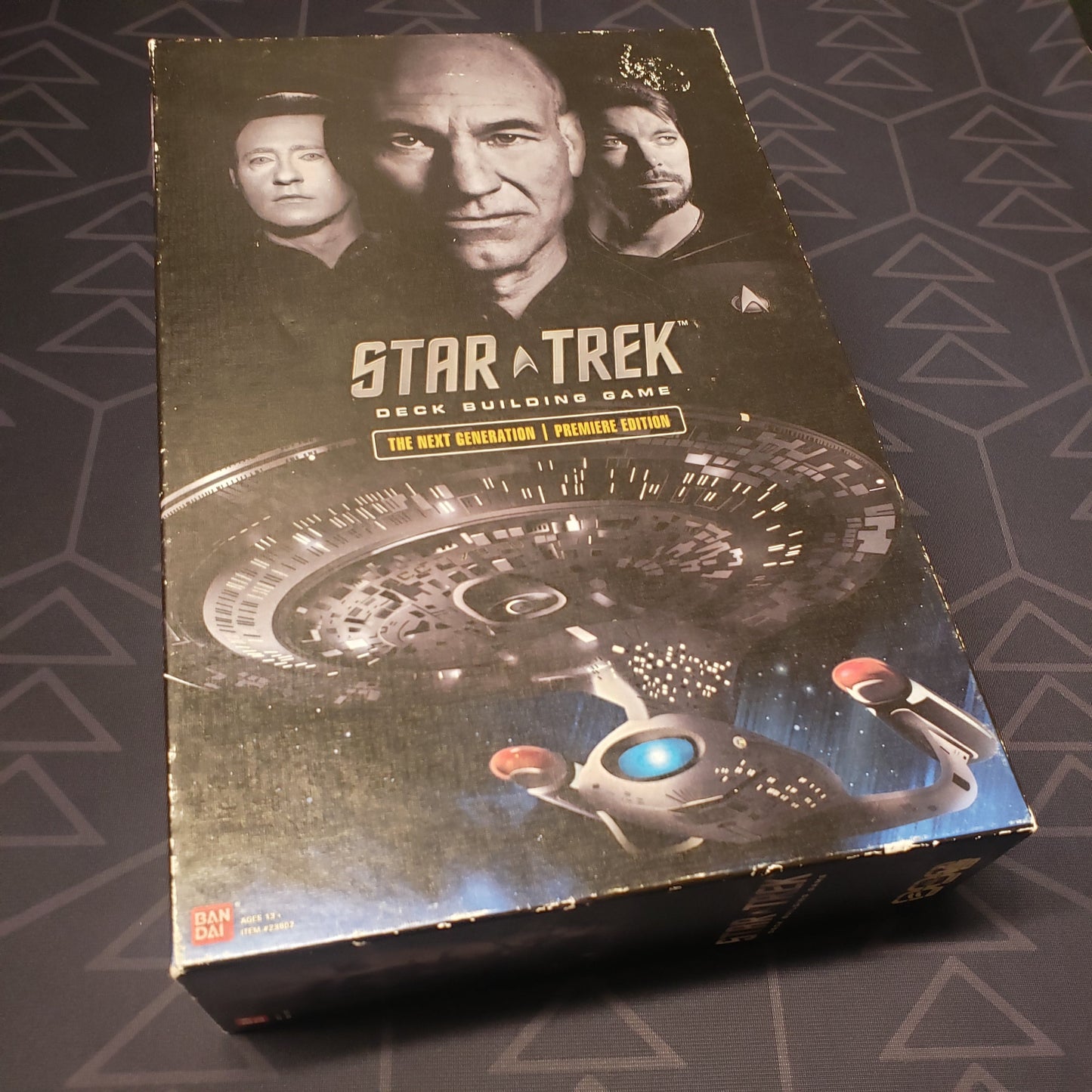 Image shows the front cover of the box of the card game Star Trek Deck Building Game: The Next Generation