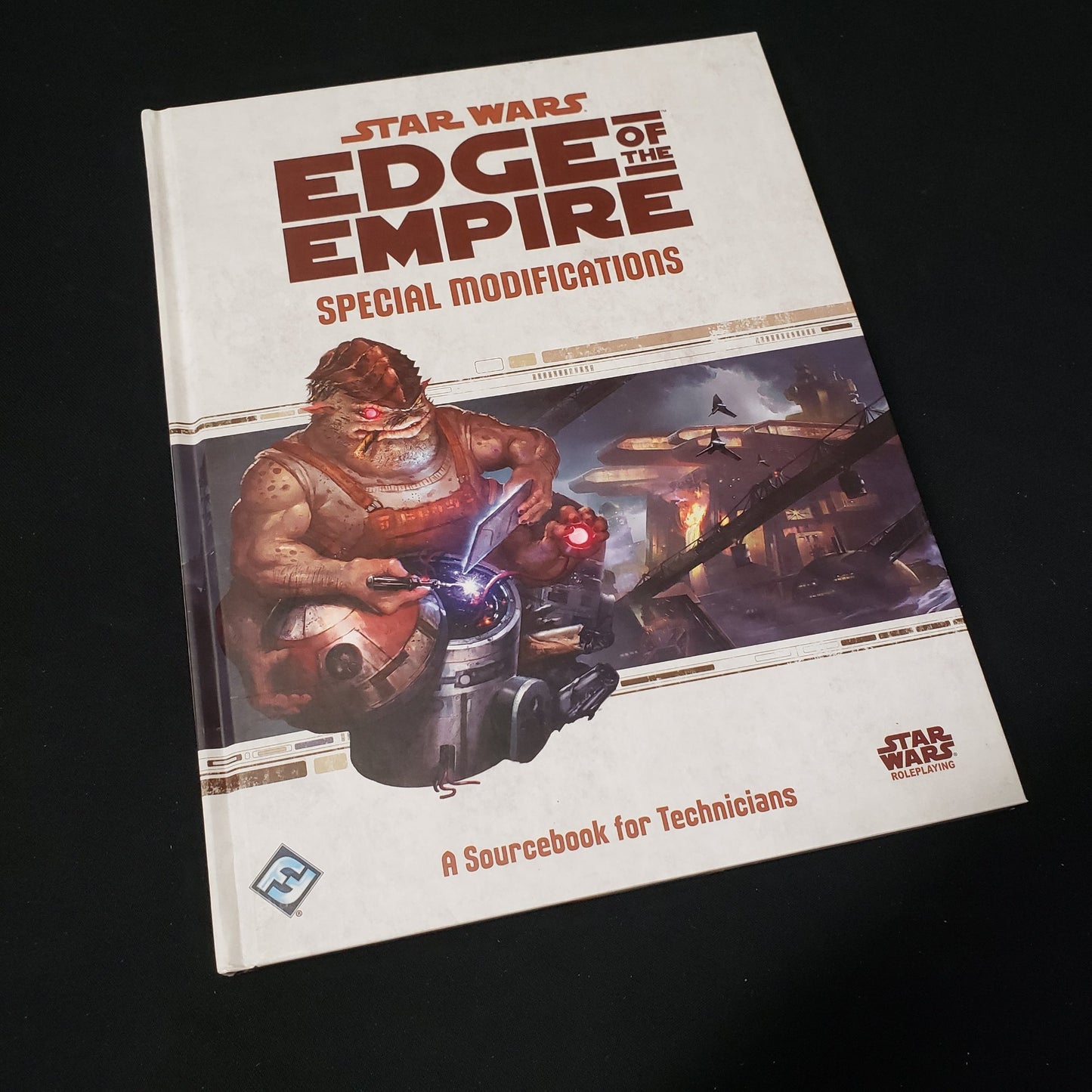 Image shows the front cover of the Special Modifications book for the roleplaying game Star Wars: Edge of the Empire