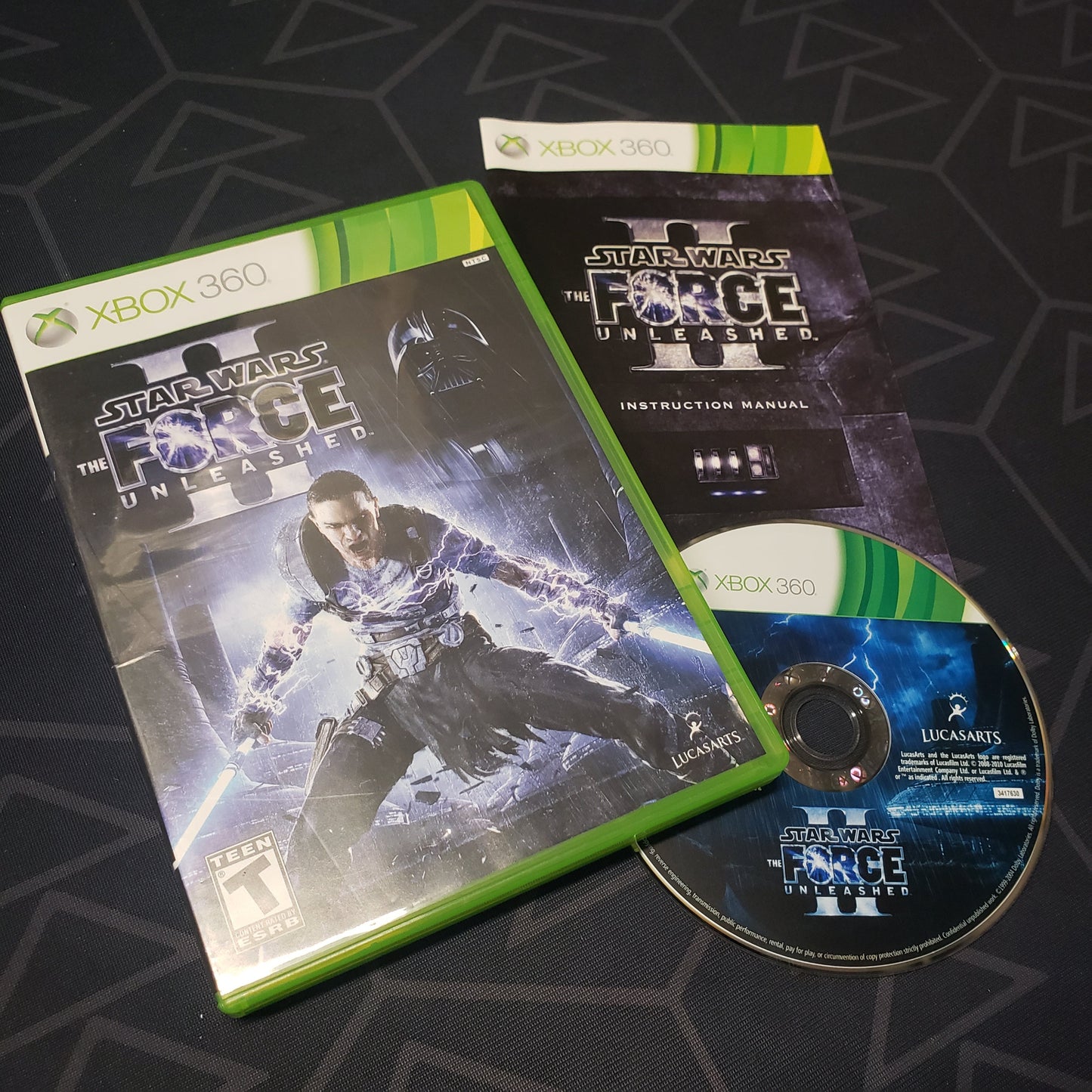 Image shows the case, manual and disc for the video game Star Wars: The Force Unleashed II for Xbox 360