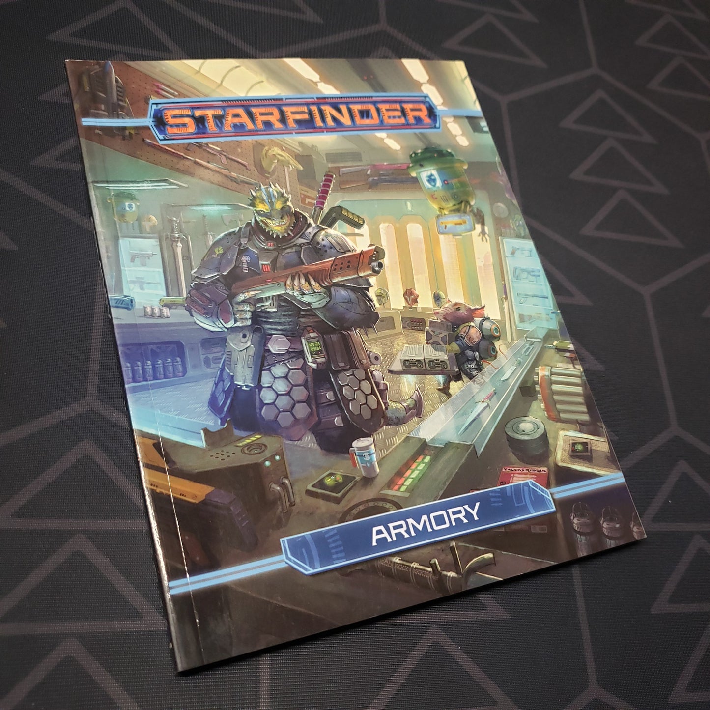 Image shows the front cover of the Armory (Pocket Edition) book for the roleplaying game Starfinder 1E