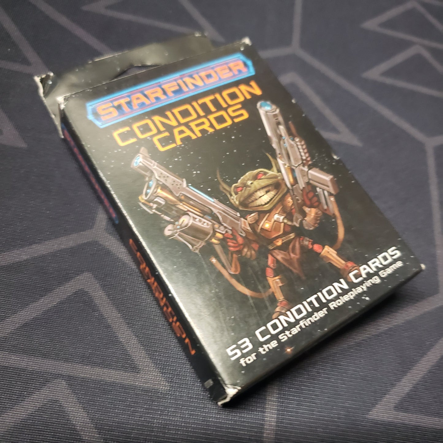 Image shows the front cover of the Condition Cards Deck box for the roleplaying game Starfinder 1E