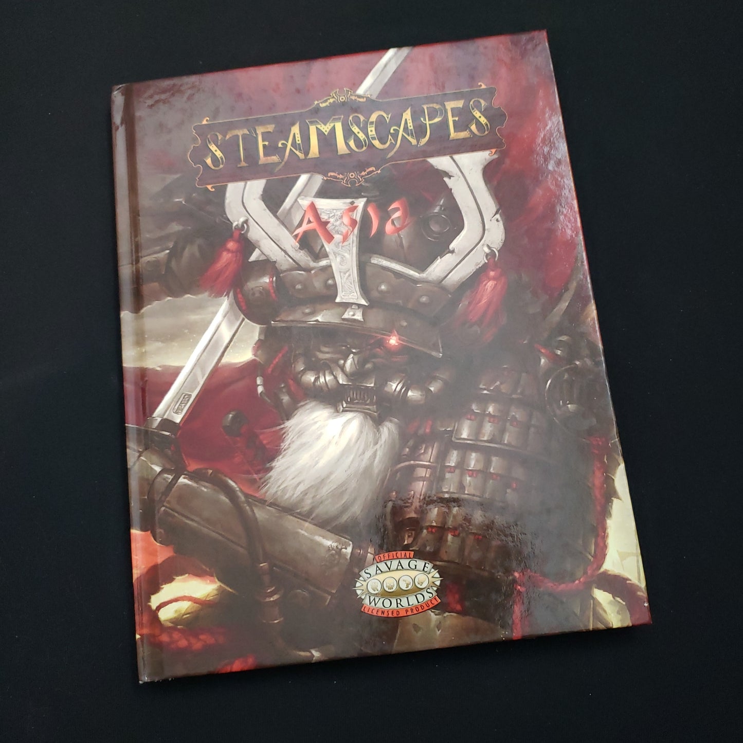 Image shows the front cover of the Steamscapes: Asia book for the Savage Worlds roleplaying game