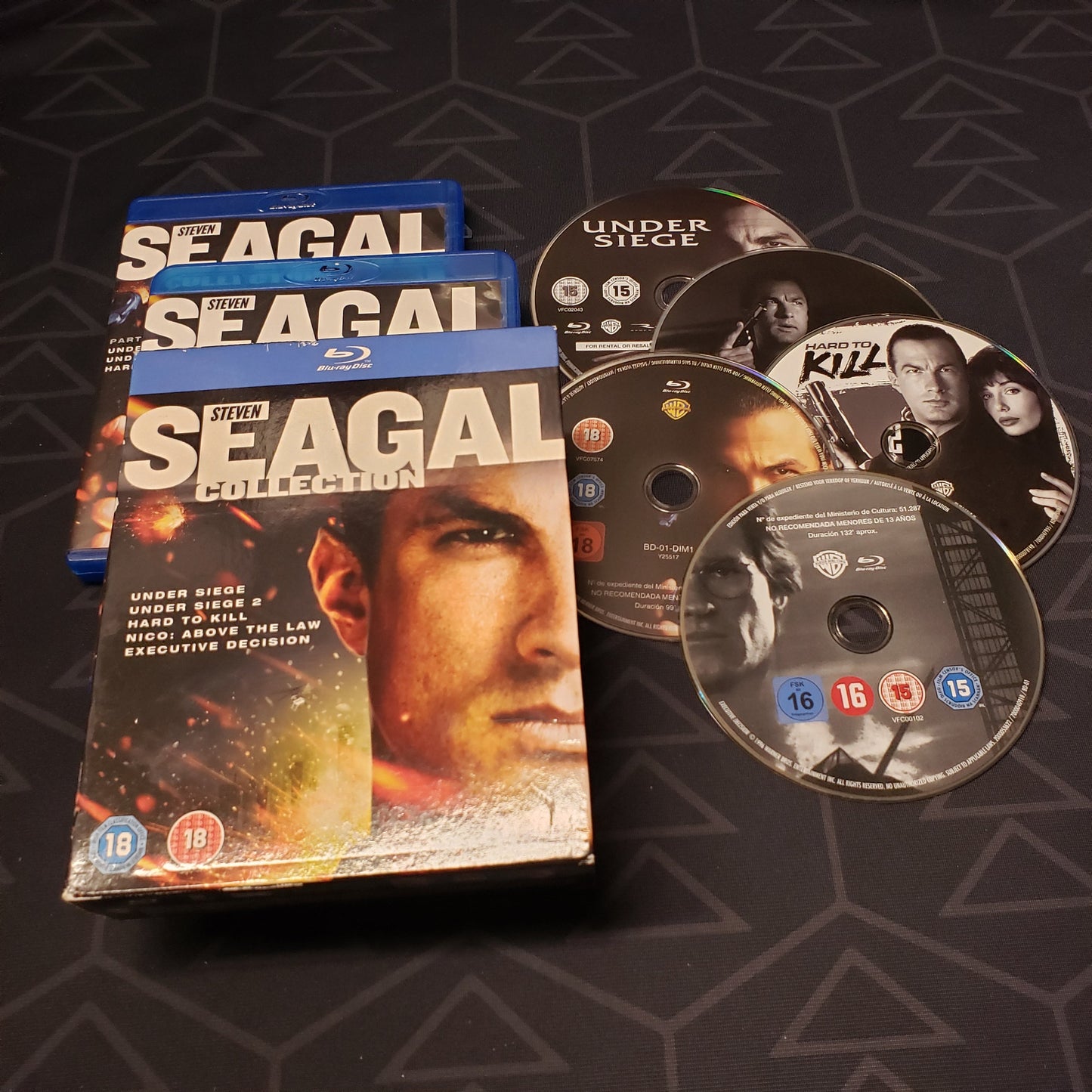 Image shows the cases, outer box & five discs for the Steven Seagal Collection movie set on Blu-Ray