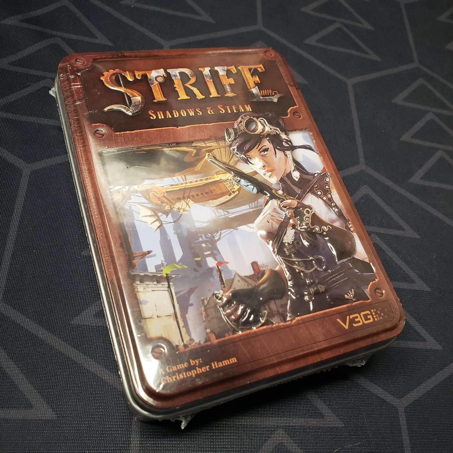 Image shows the front cover of the box for the Strife: Shadows & Steam card game