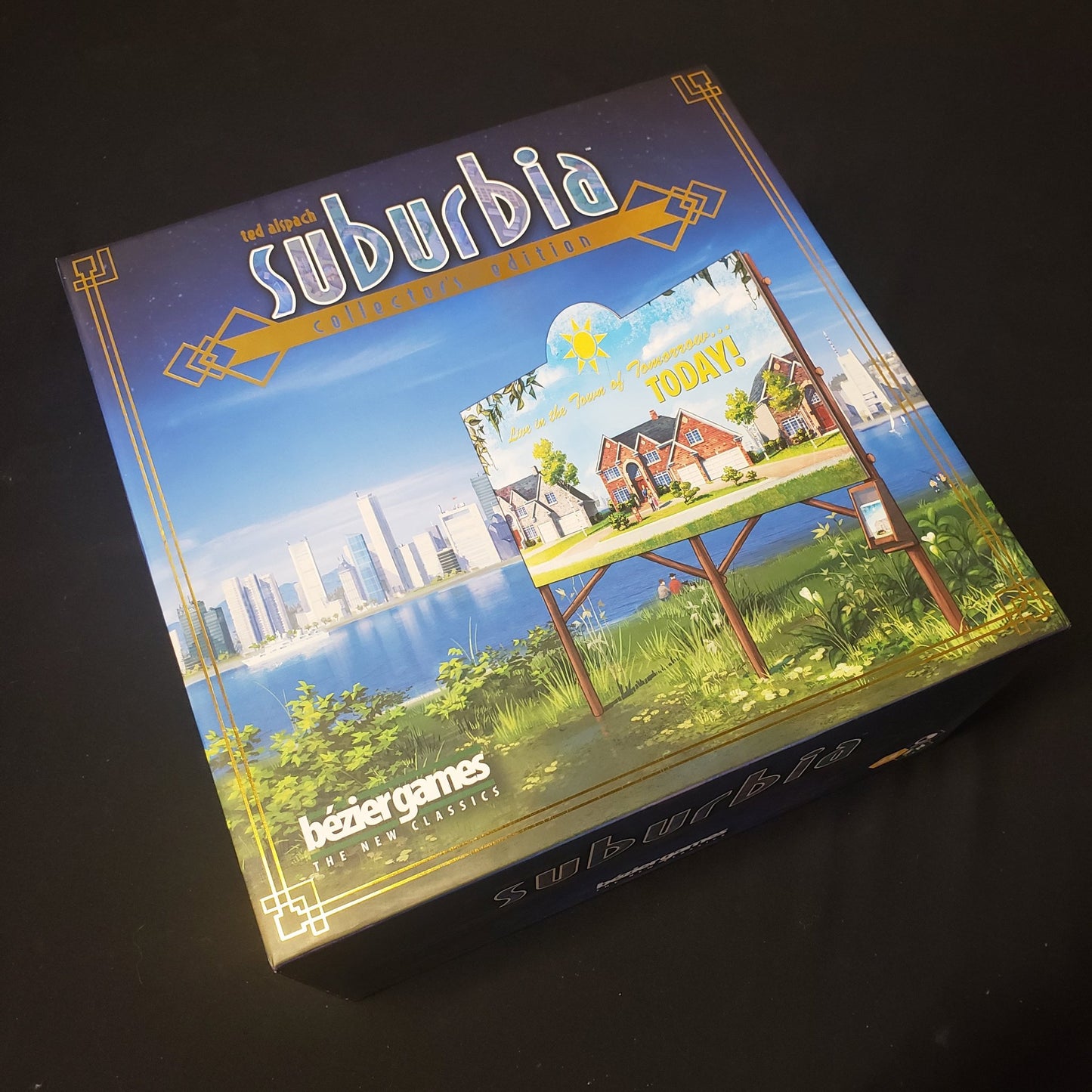 Image shows the front cover of the box of the board game Suburbia: Collector's Edition