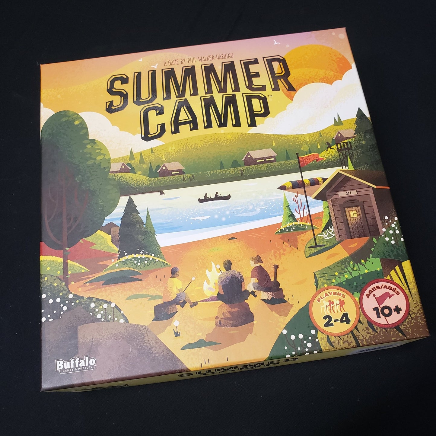 Image shows the front cover of the box of the Summer Camp board game