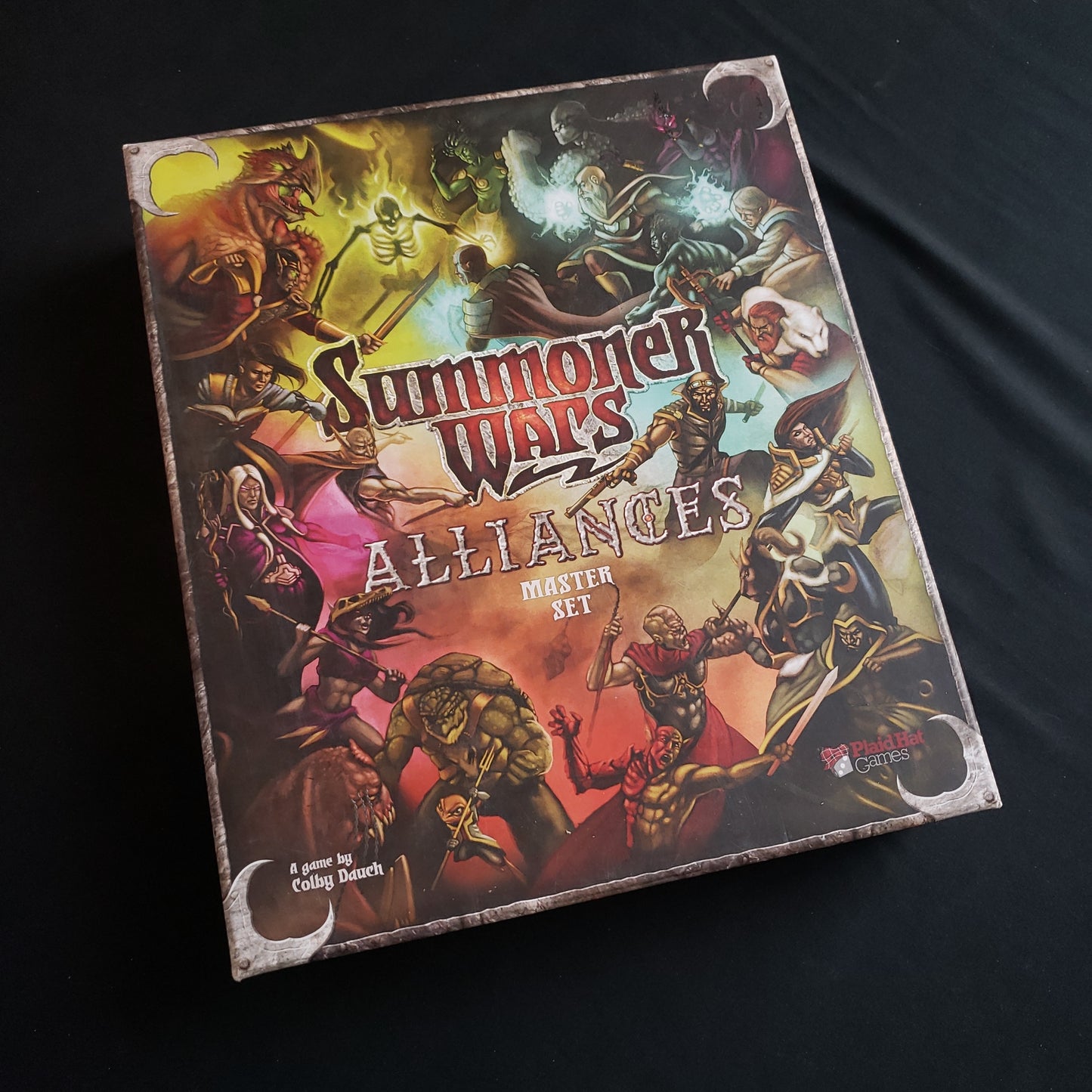 Image shows the front cover of the box of the Alliances Master Set for the Summoner Wars card game
