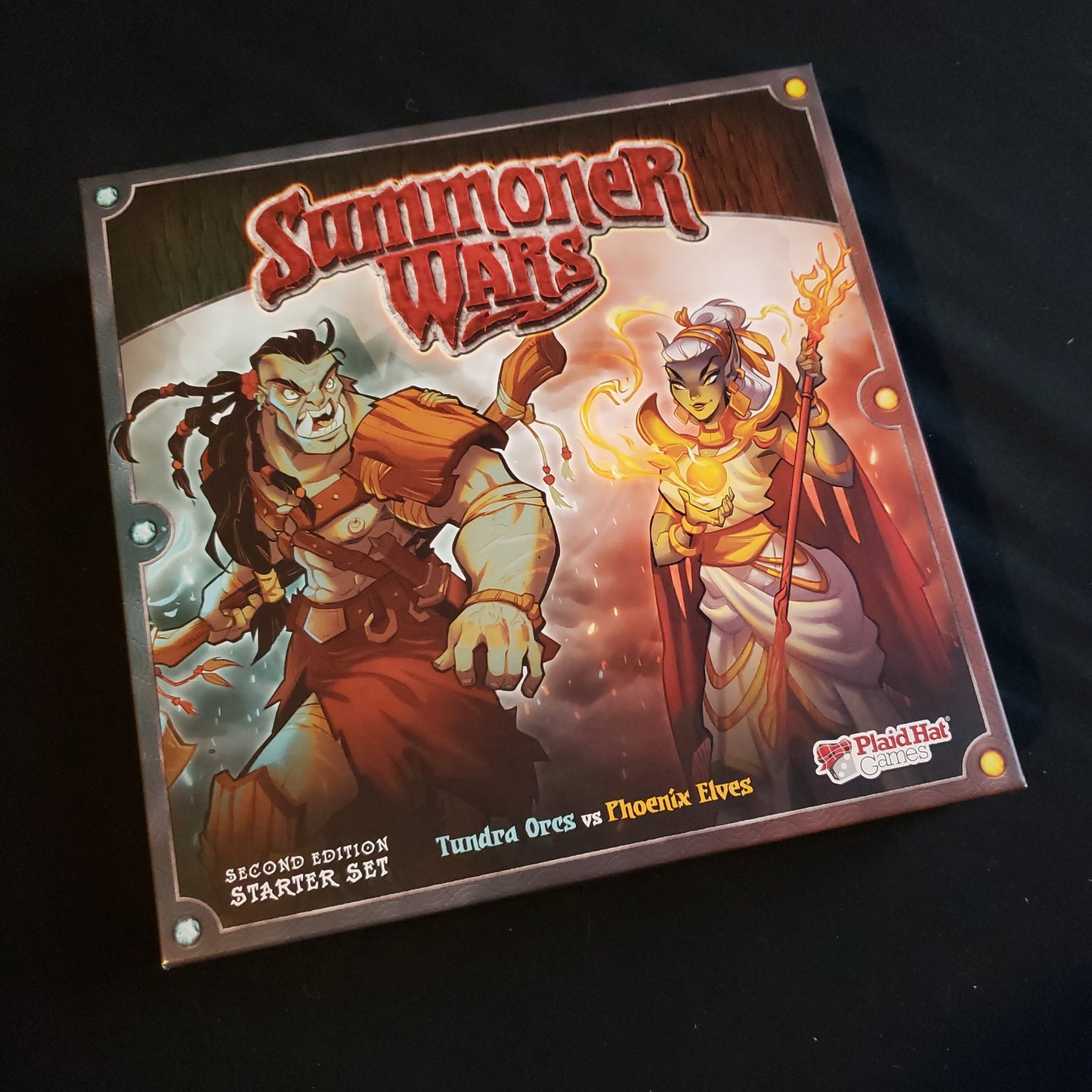 Image shows the front cover of the box of the Second Edition Starter Set for the Summoner Wars card game