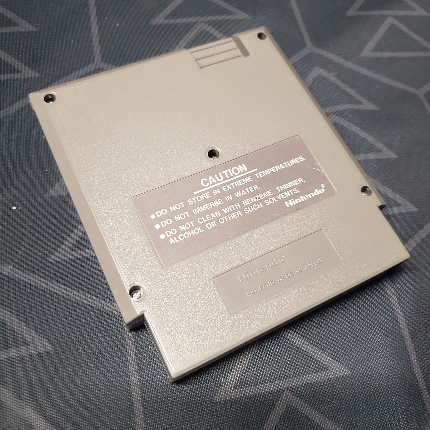 Image shows the back of the cartridge for the video game Super Mario Bros. for the Nintendo Entertainment System