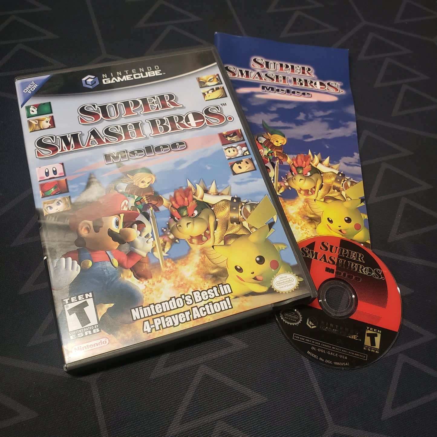 Image shows the case, manual and disc for the video game Super Smash Bros. Melee for Nintendo GameCube
