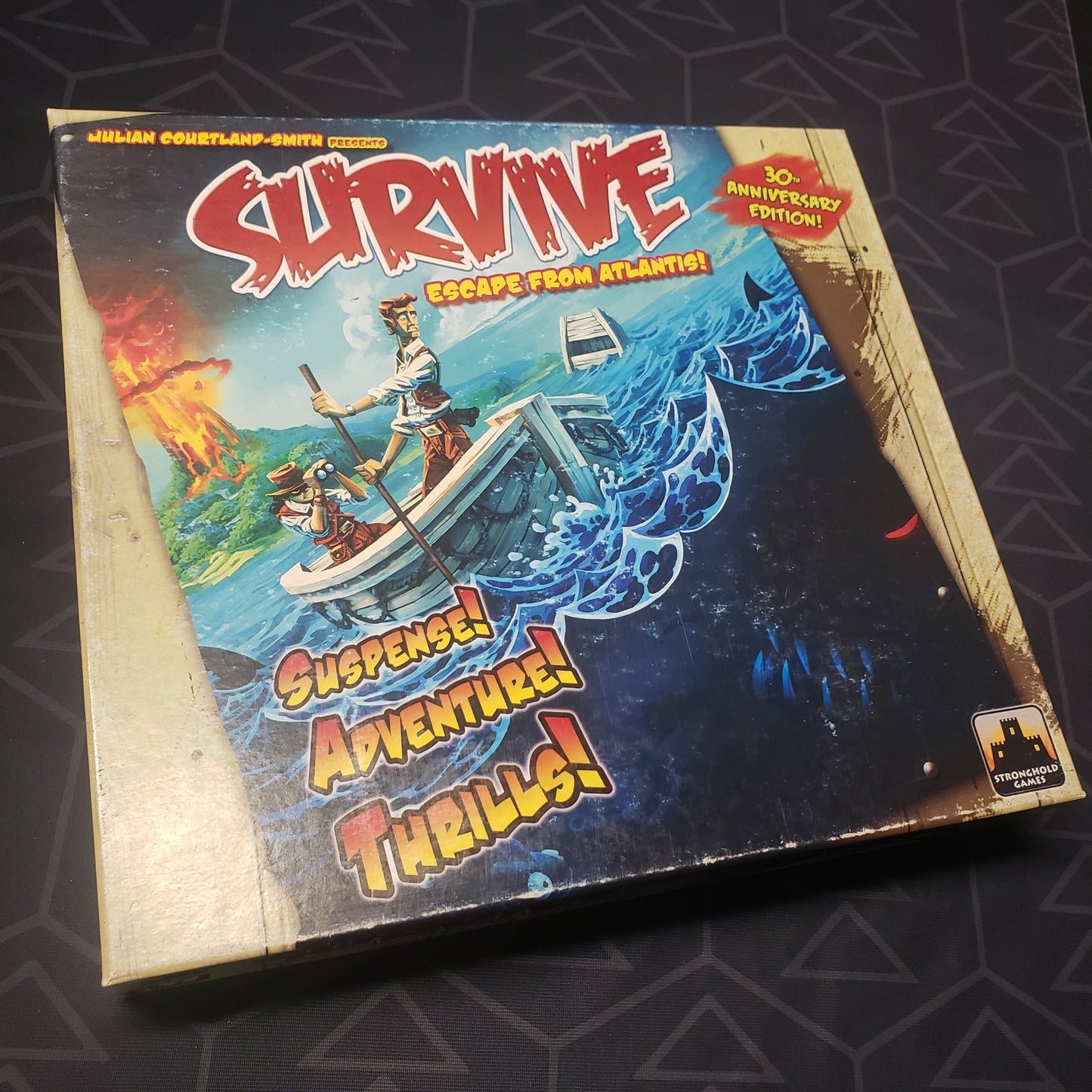 Image shows the front cover of the box of the board game Survive: Escape From Atlantis