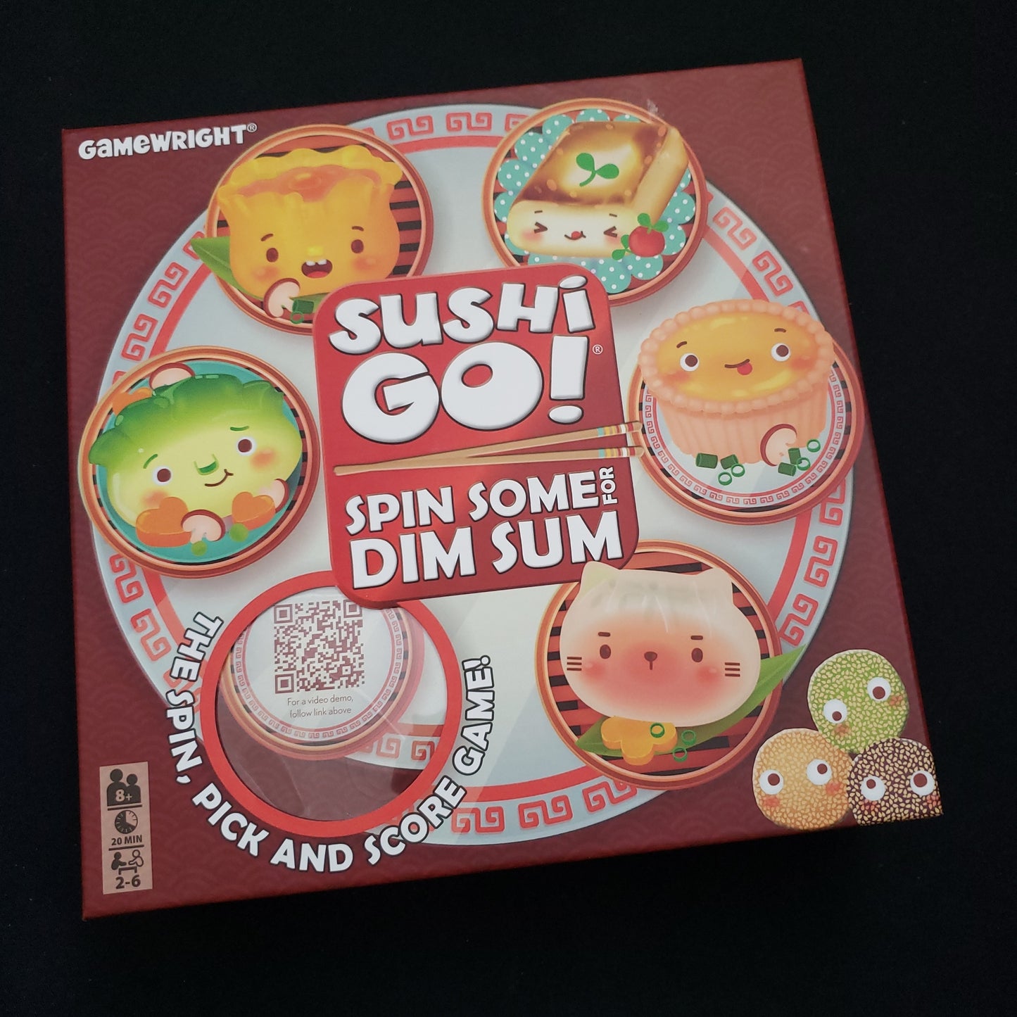 Image shows the front cover of the box of the Sushi Go: Spin Some for Dim Sum board game