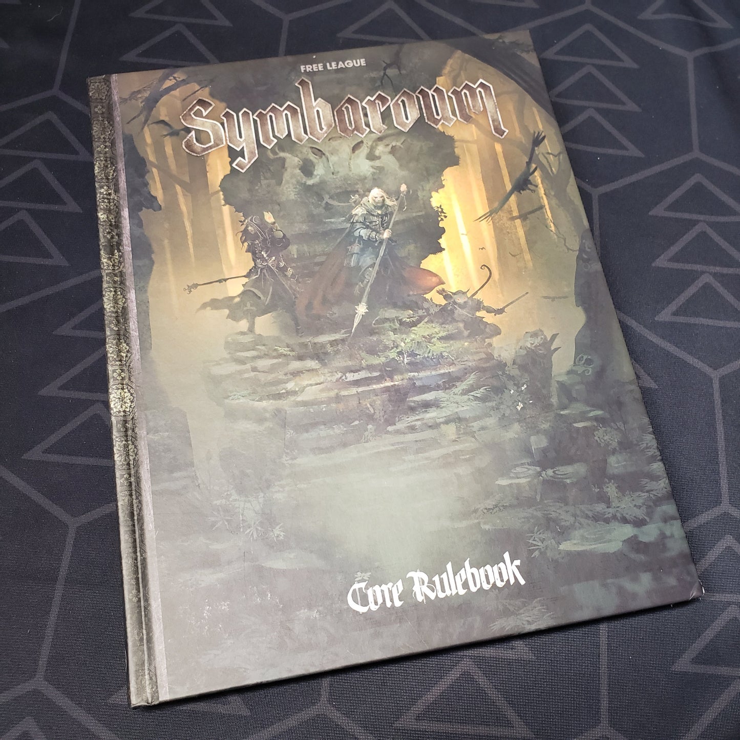 Image shows the front cover of the core rulebook for the roleplaying game Symbaroum