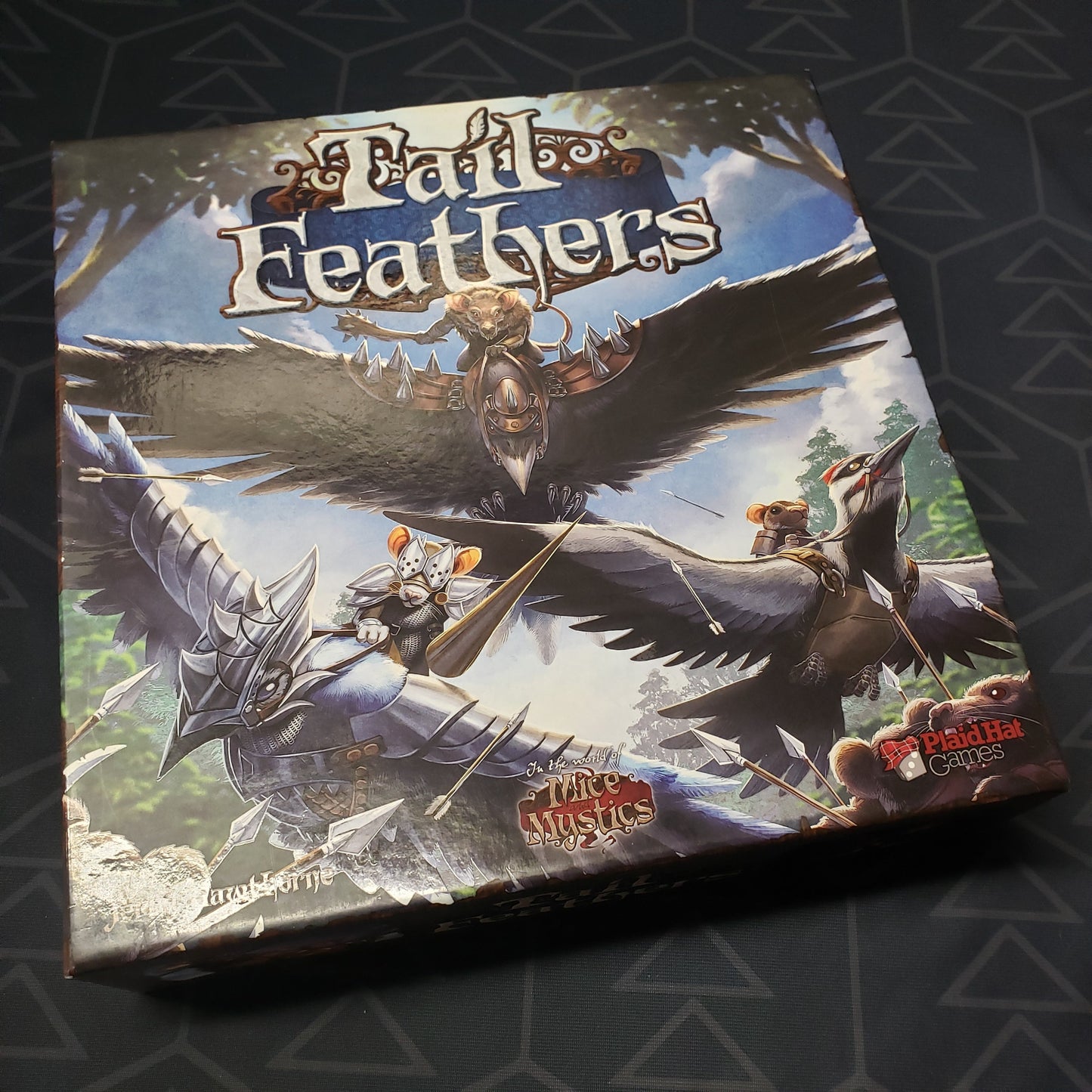 Image shows the front cover of the box for the Tail Feathers board game