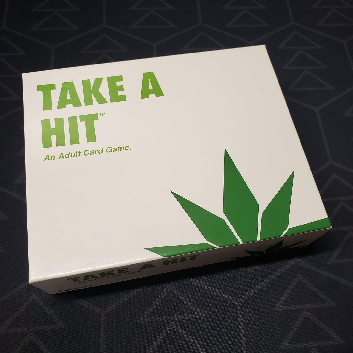 Image shows the front cover of the box for the Take a Hit card game