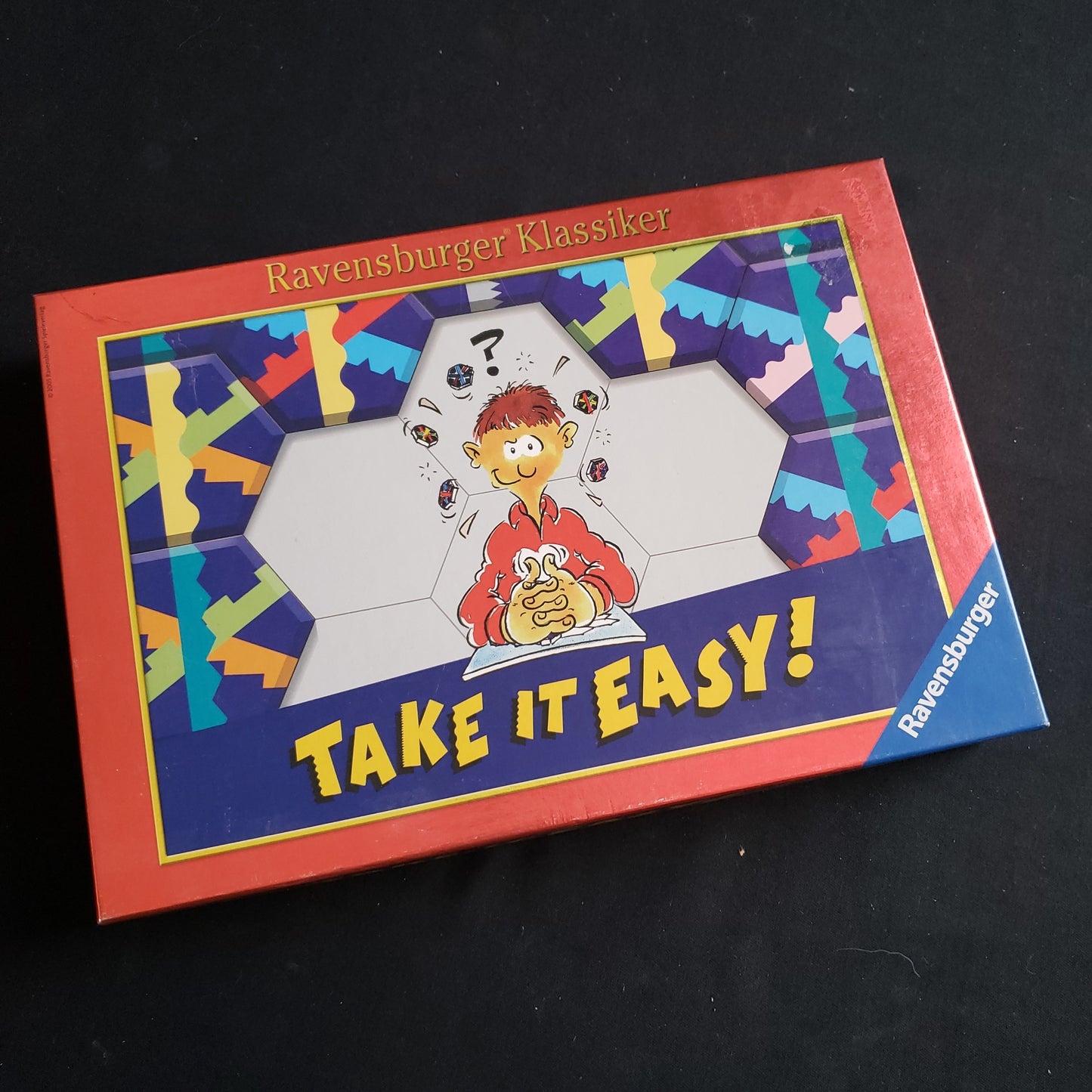 Image shows the front cover of the box of the Take It Easy board game