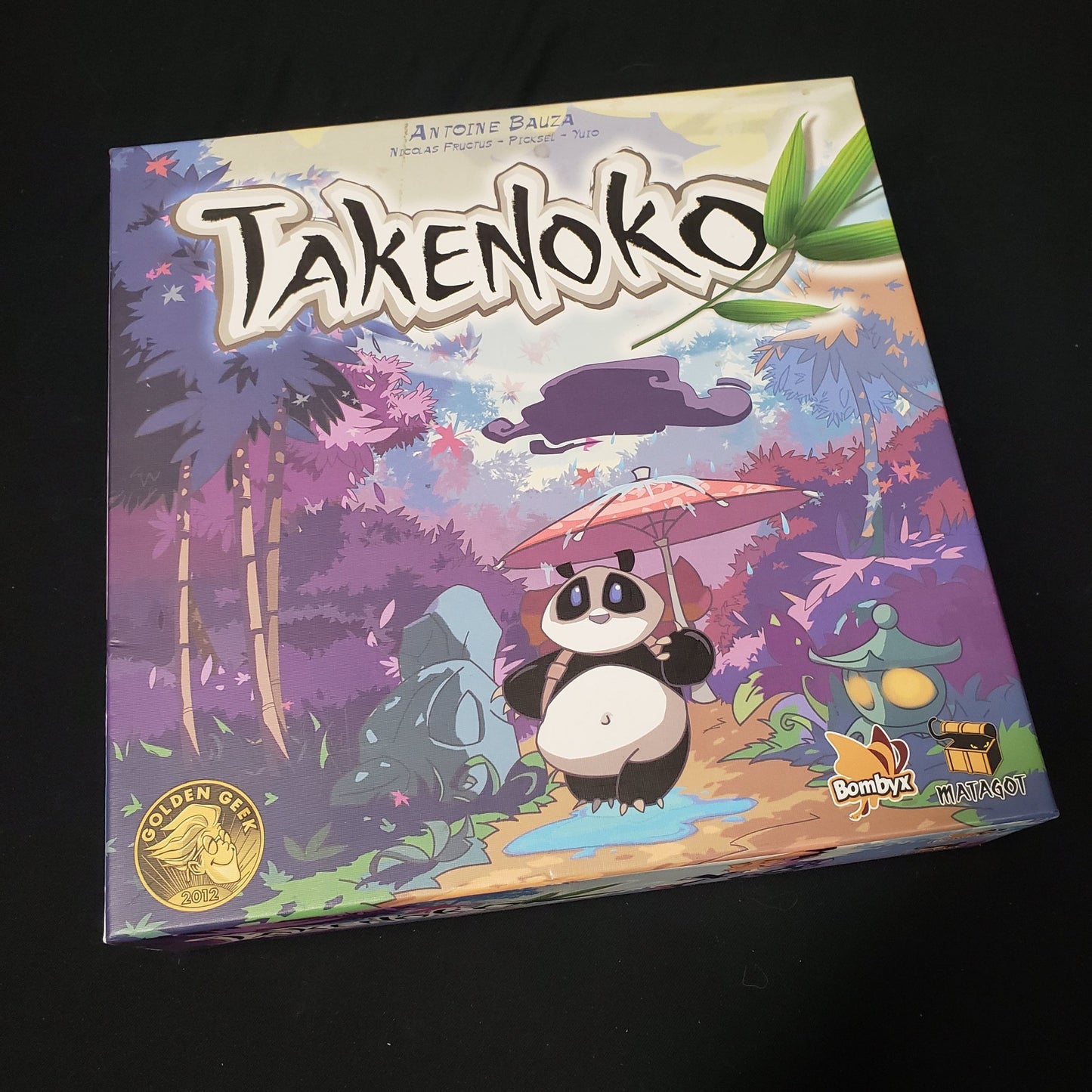 Image shows the front cover of the box of the Takenoko board game